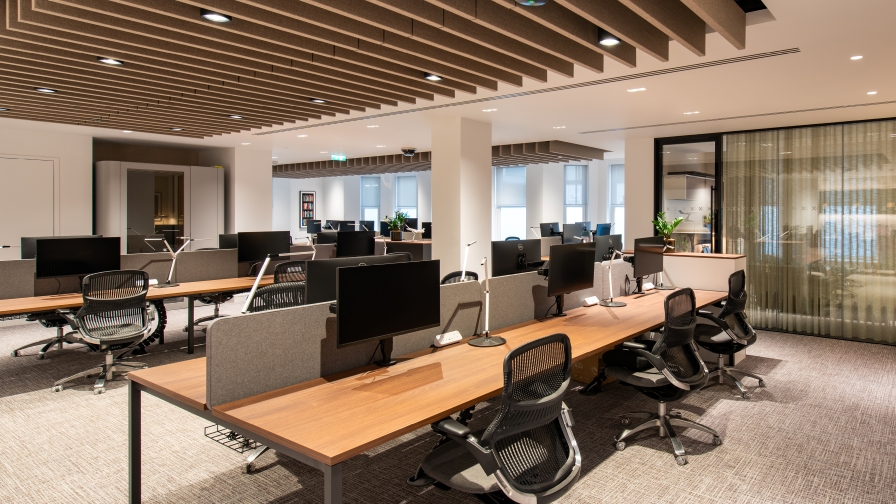 Open plan workspace with acoustic ceiling and office