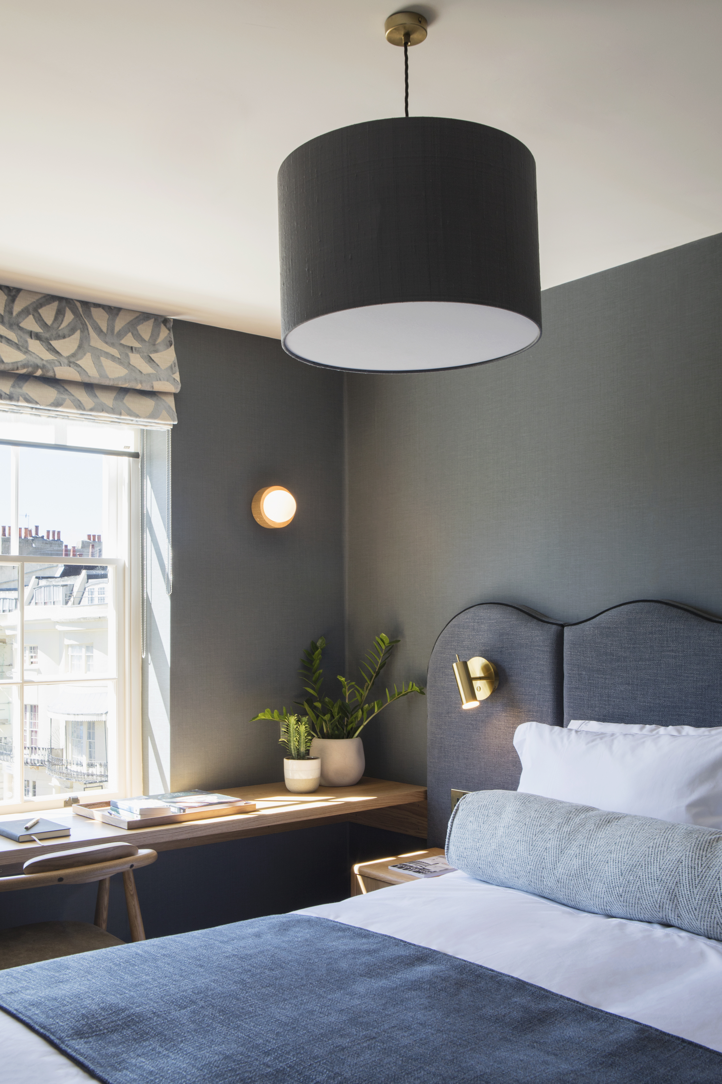 Contemporary bedroomwith bespoke headboard, blue walls and integrated desk at 29 Rwegency Square, Brighton