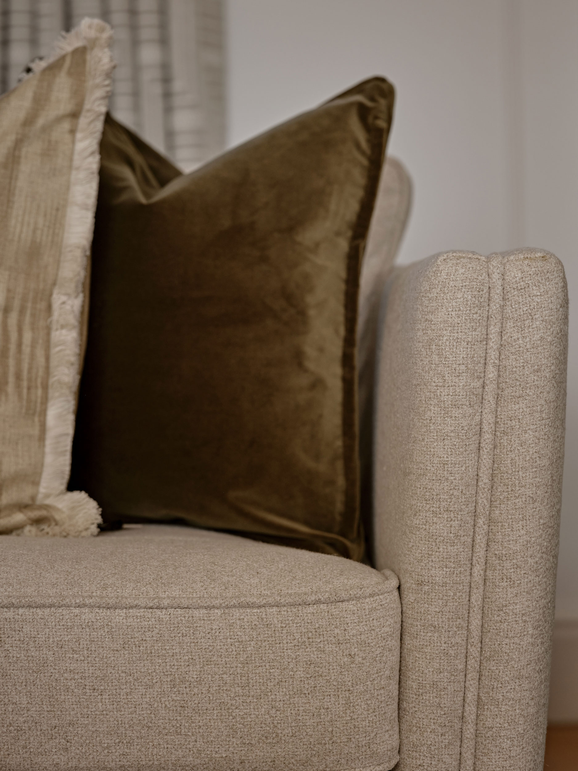 Oatmeal upholstered sofas and velvet cushions bespoke made by Origins Design