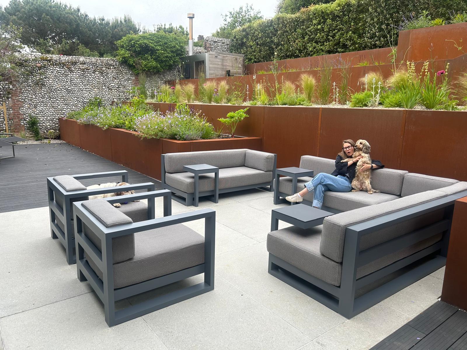 Image of woman relaxing with dog on Posidonia lounge furniture by Vondom