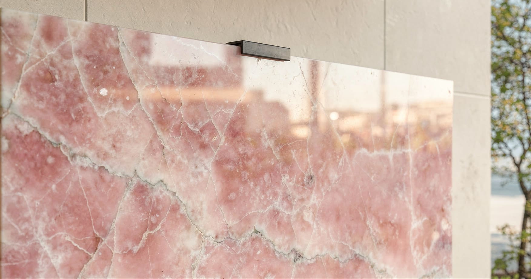 Close-up of polished Pink Onyx with soft blush tones with top metal clamp 