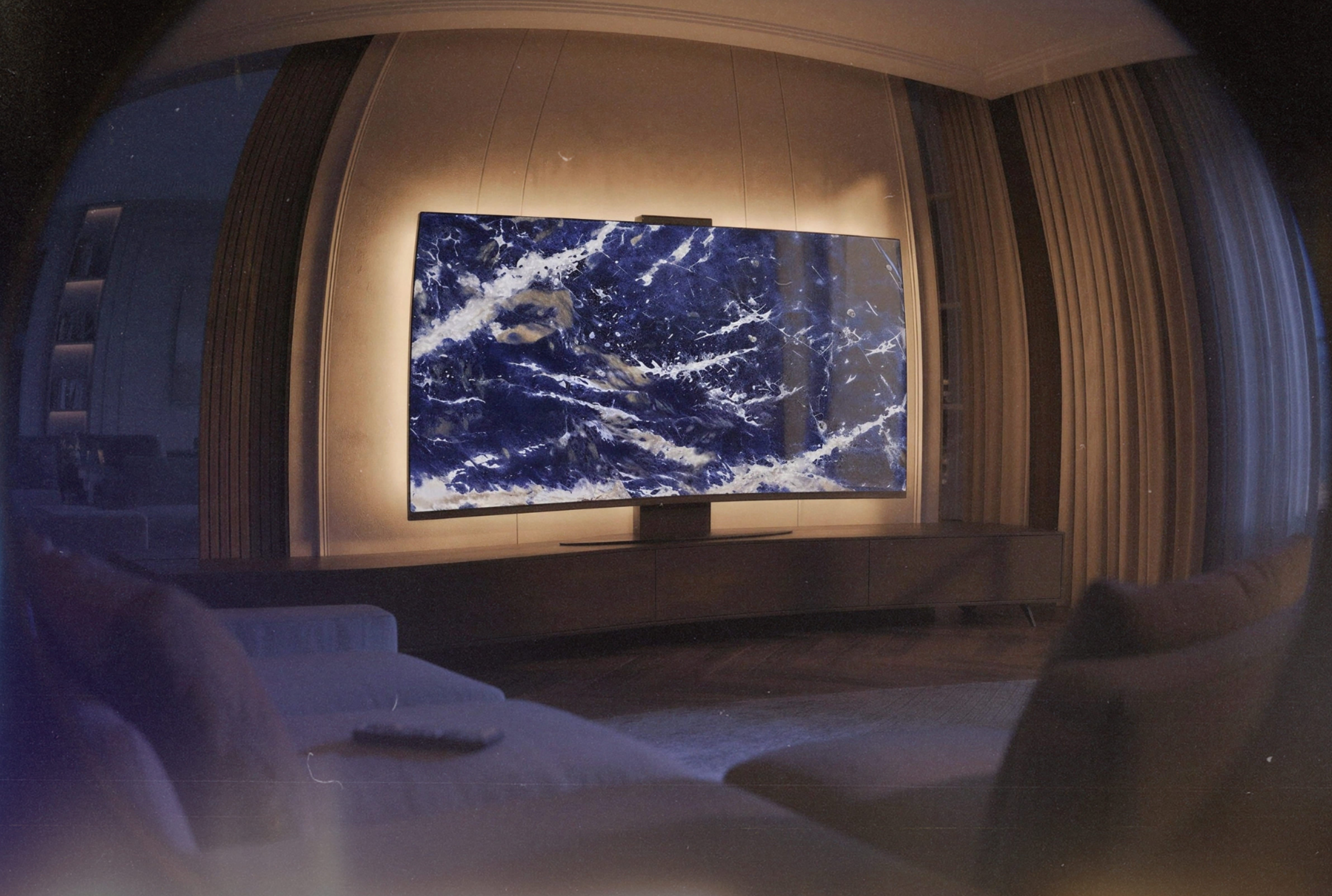 Halo Screen in Sodalite Blue gemstone with warm concealed halo backlight in a luxury evening living room