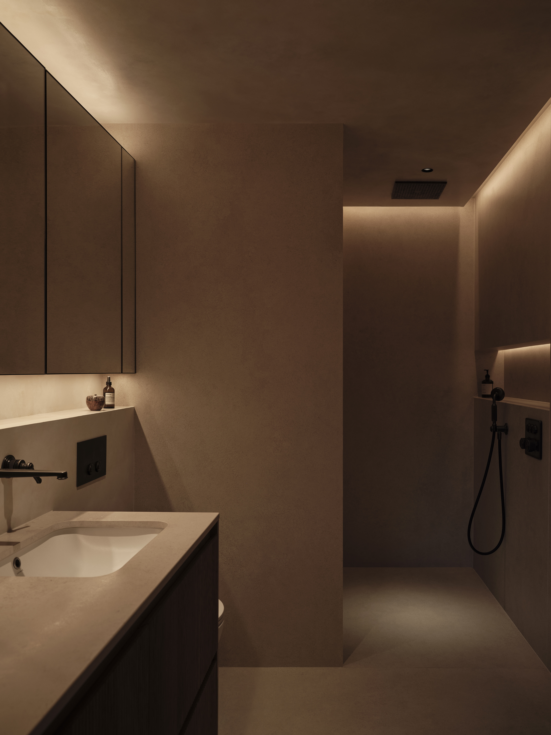 Warm-toned bathroom with a floating vanity, mirrored cabinetry and a walk-in shower illuminated by concealed lighting, designed by Designed by Woulfe.