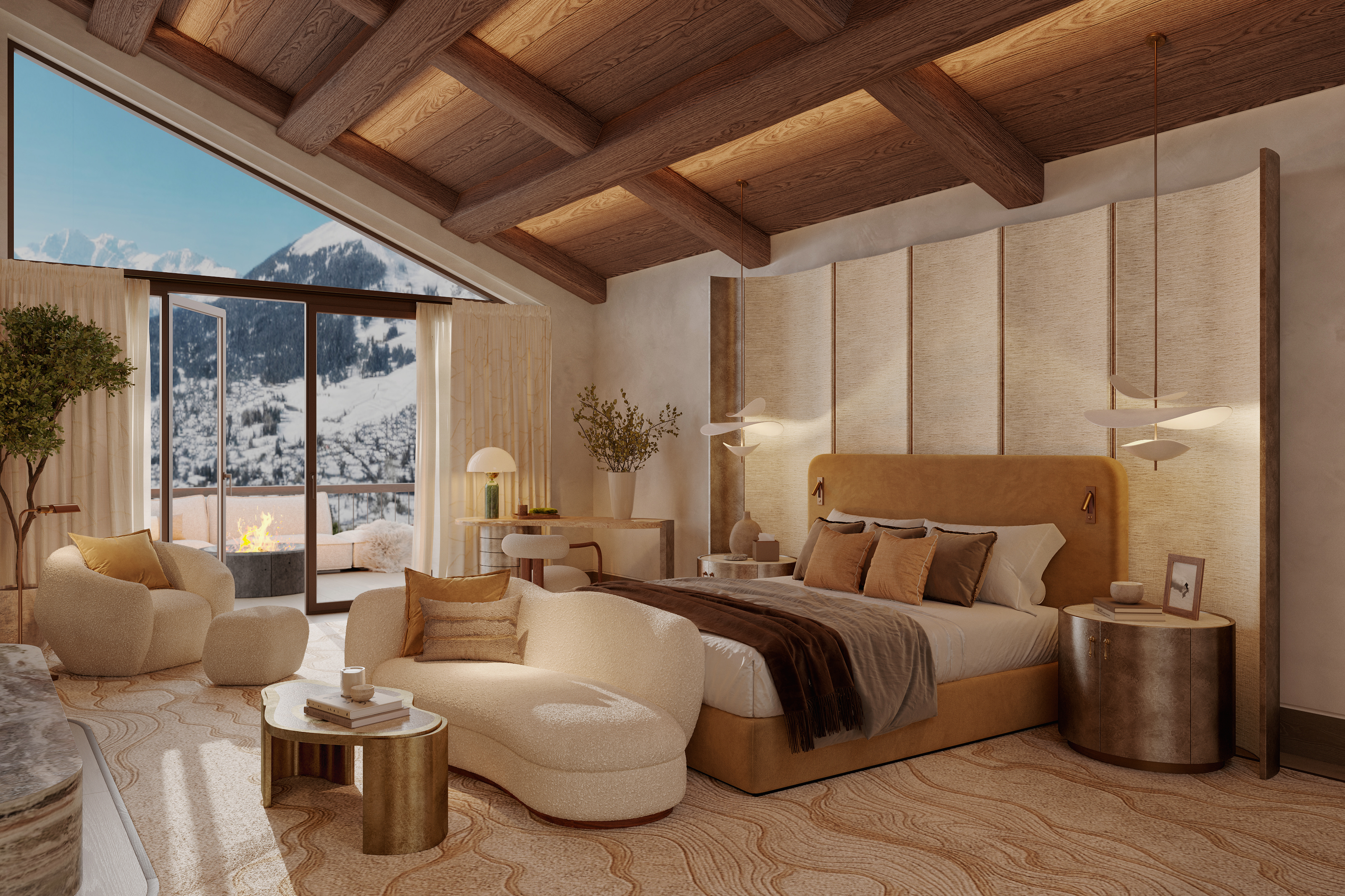Chalet bedroom with a tall upholstered headboard, exposed timber beams and curved cream seating beside windows overlooking snowy mountains.