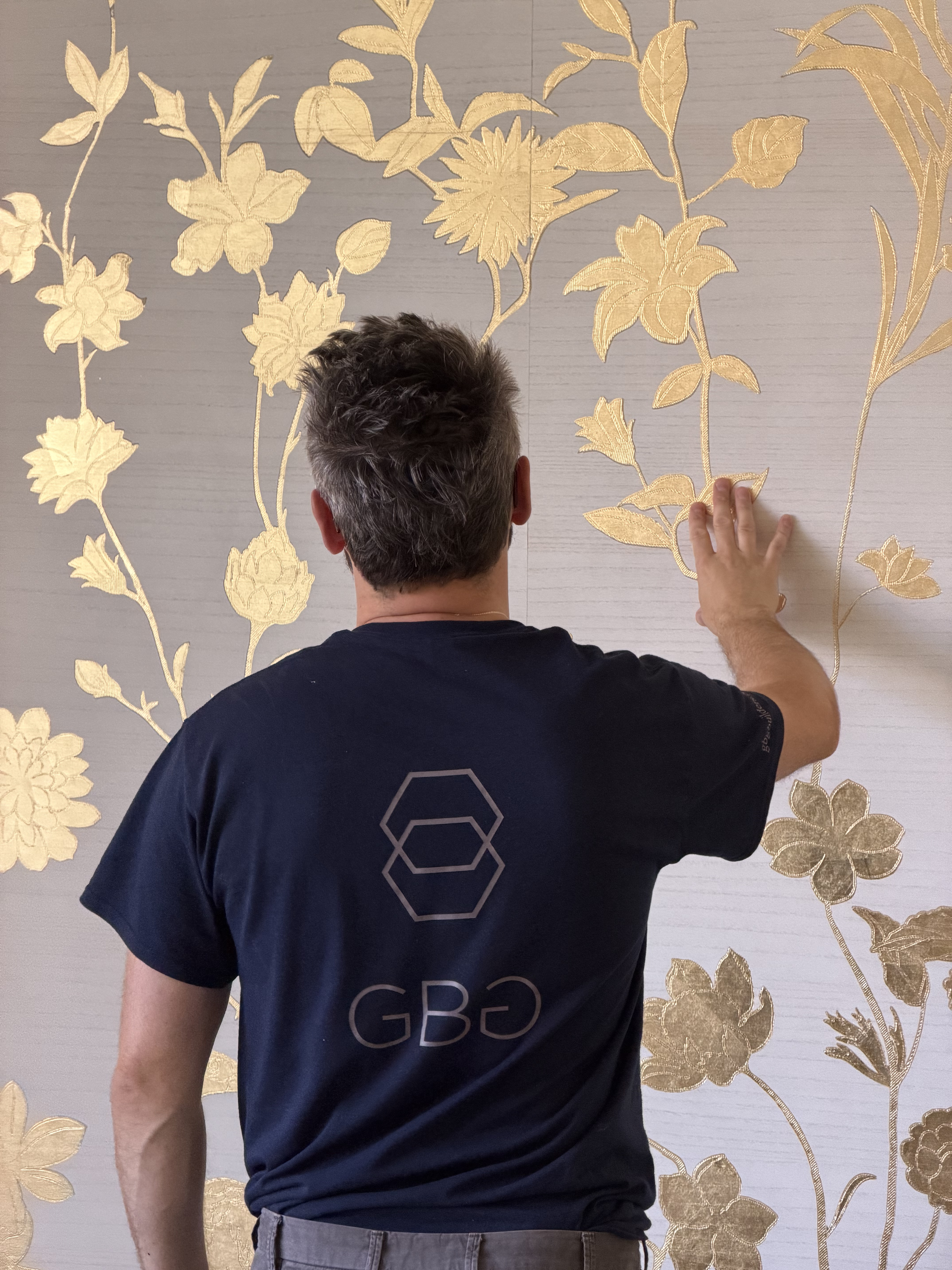 GBG quality inspection of gold leaf wallpaper installation.