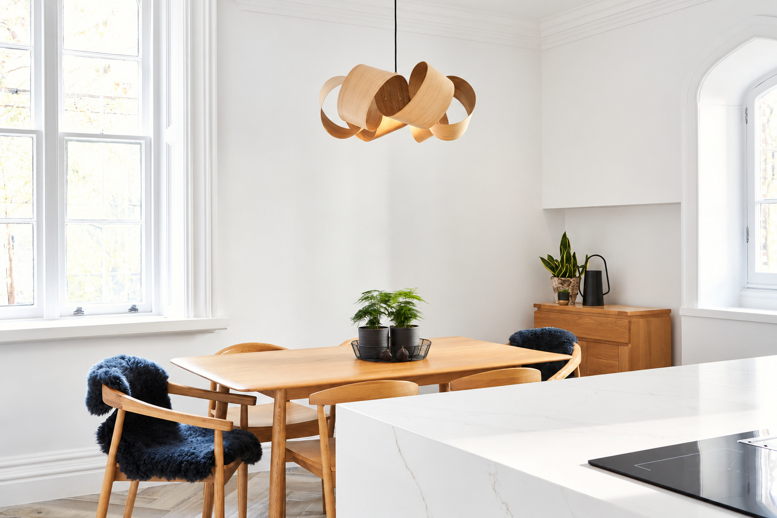Scandinavian look dining area in contemporary white kitchen at Carter Manor in Wilmslow
