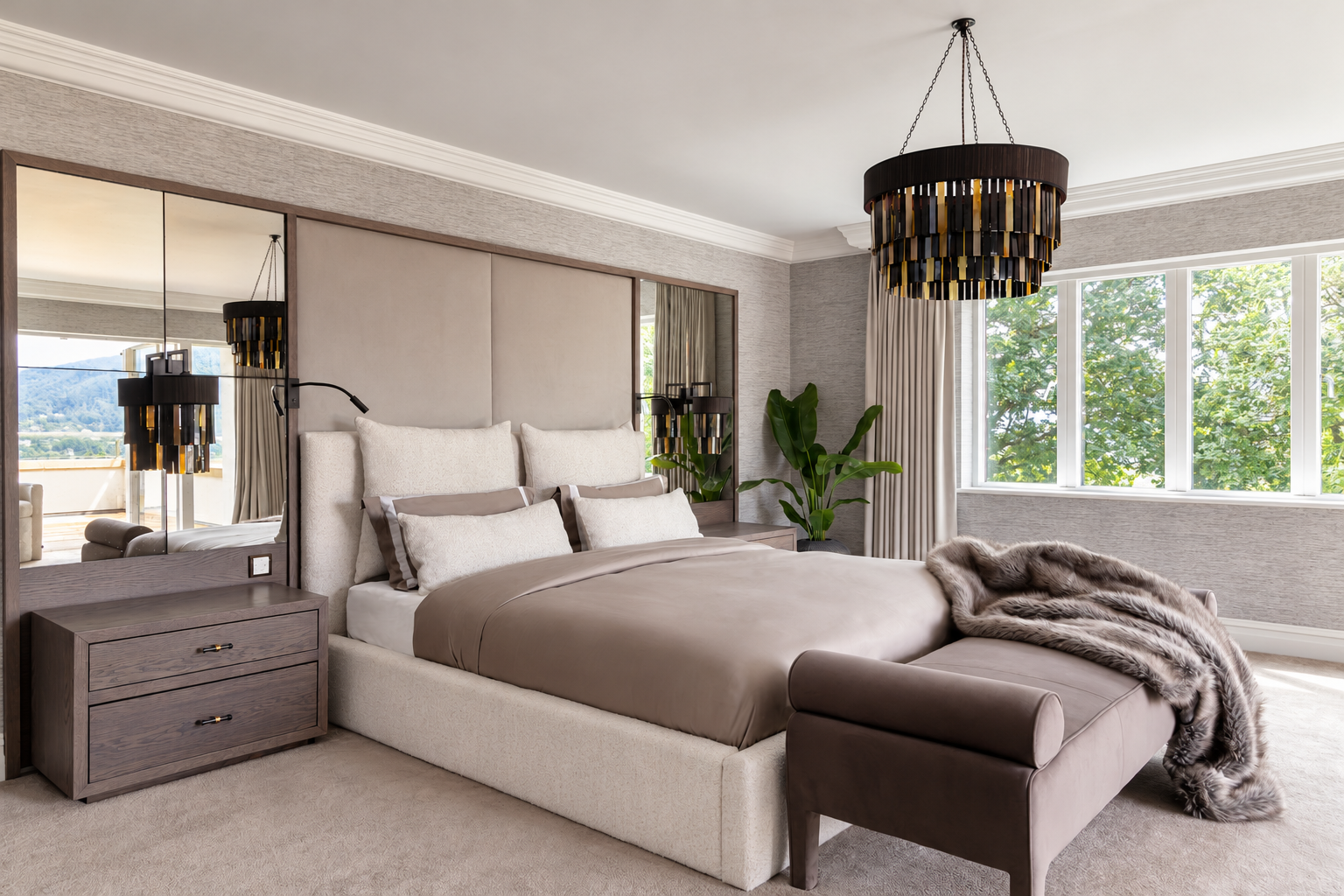 Cream upholstered bed with mirrored panels, dark bedside drawers and a taupe bench at Hillcrest House, Macclesfield.