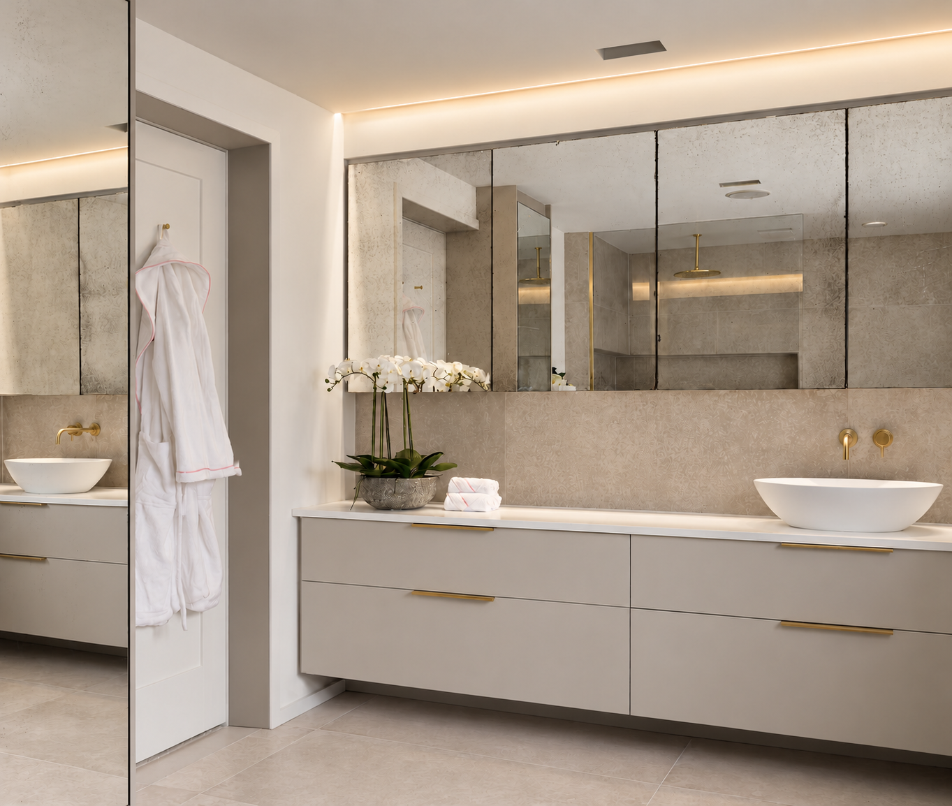 Floating ensuite vanity with brass pulls, white vessel basin, orchid and antique mirror cabinets.