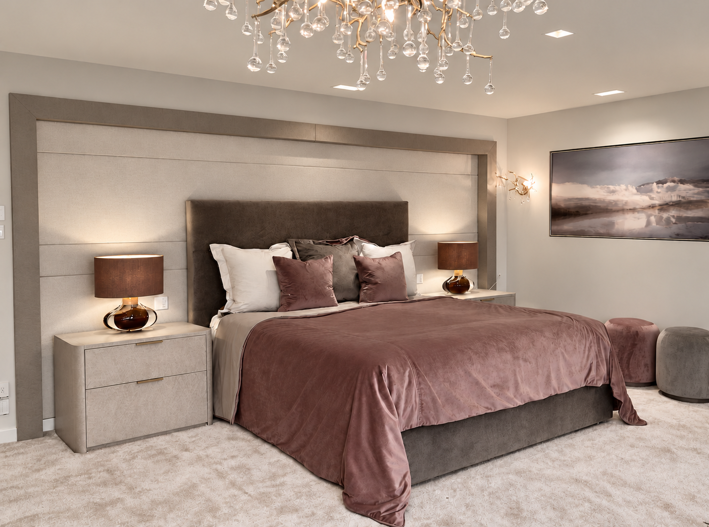 Master bedroom with velvet bedding, bespoke headboard surround and layered lighting.