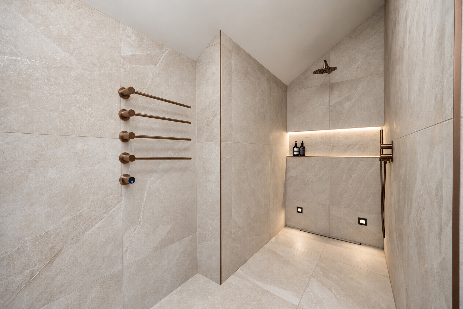 Stone-effect tiled wet room with bronze fittings and an illuminated shower niche at The Vault, Alderley Edge.
