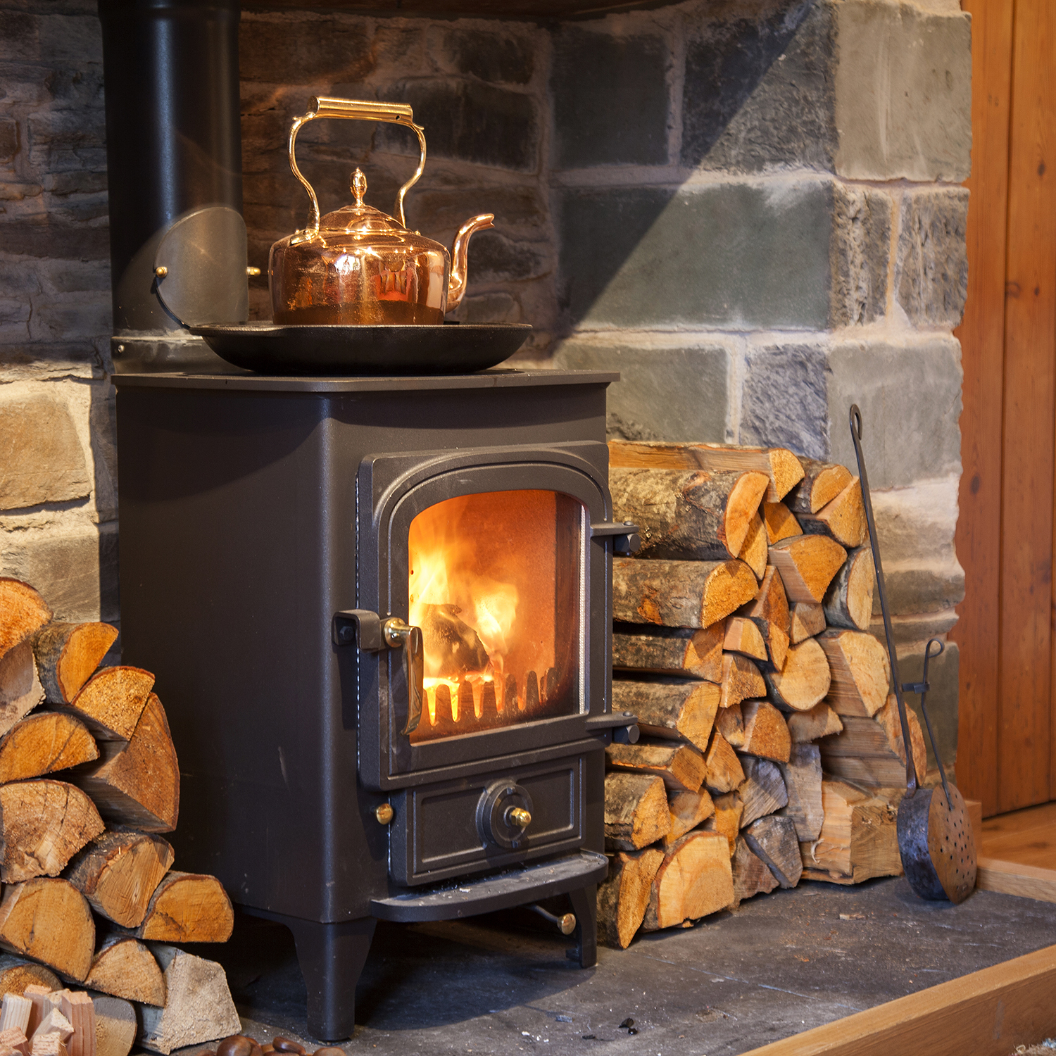 A new woodburning stove was installed within the stone fireplace.