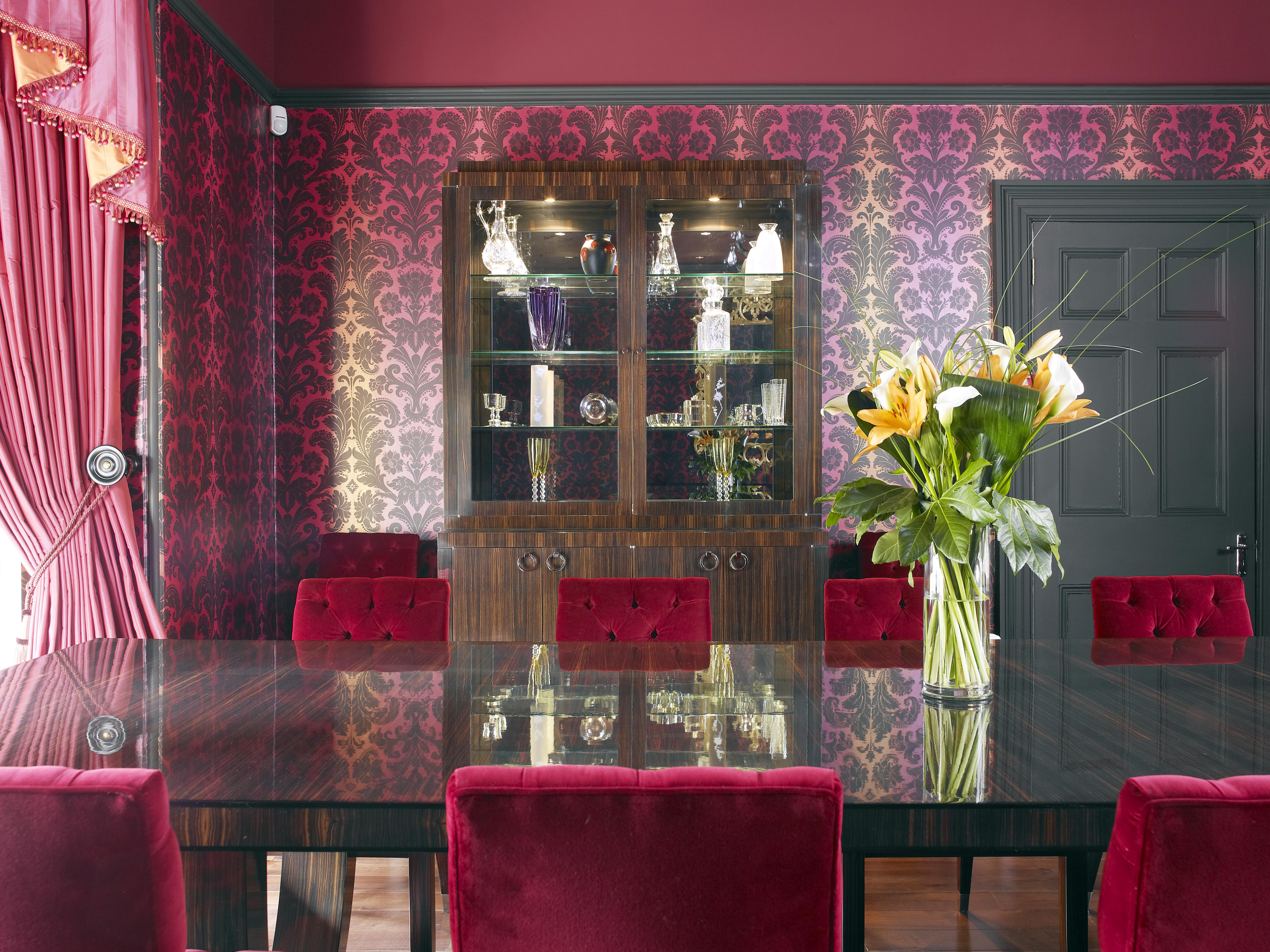 The stunning dining room features a bespoke storage/display unit, an Art Deco inspired table and velvet chairs, all in Macassar ebony