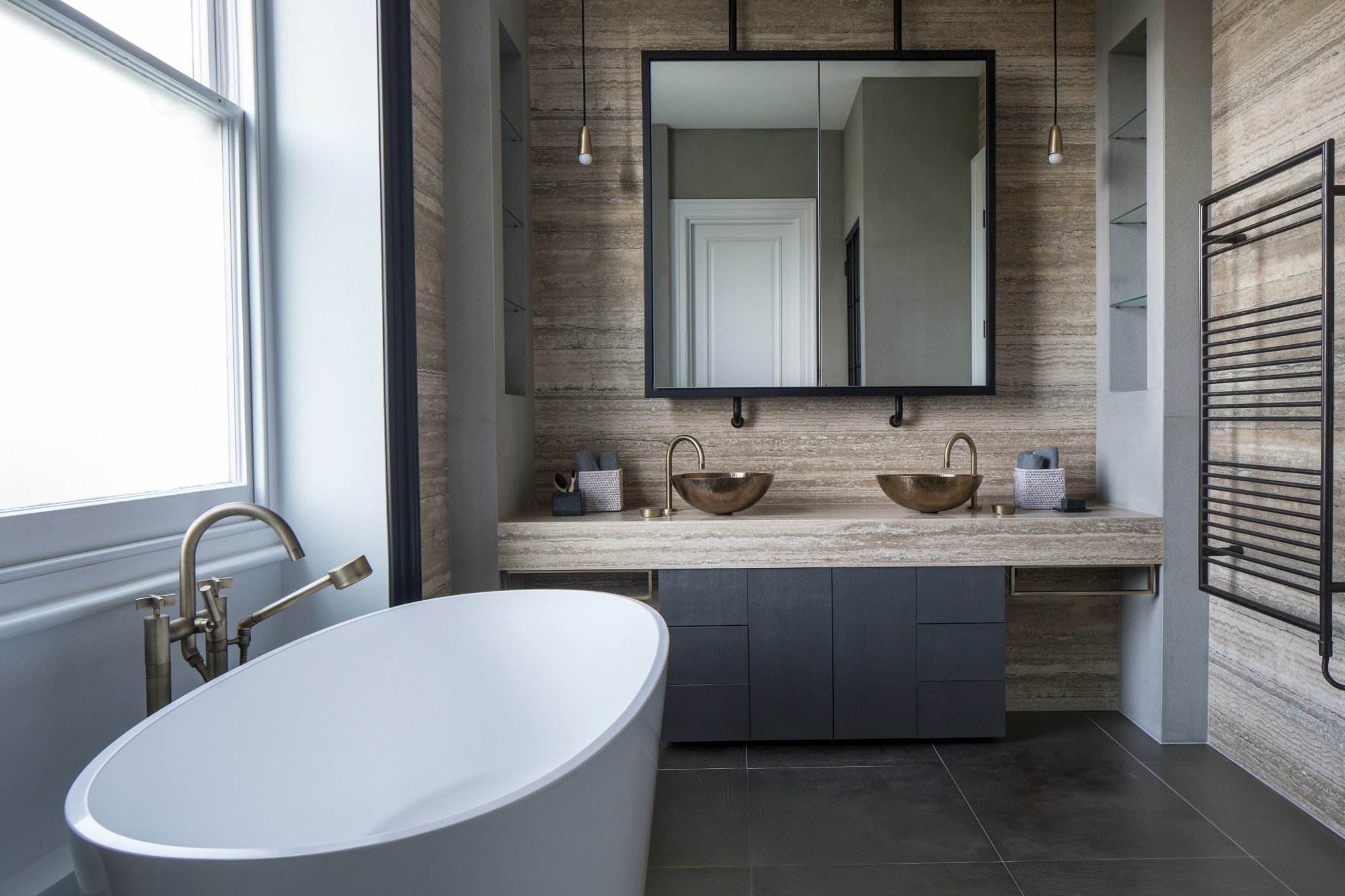contemporary industrial bathroom with limestone bathroom vanity and oval freestanding bath