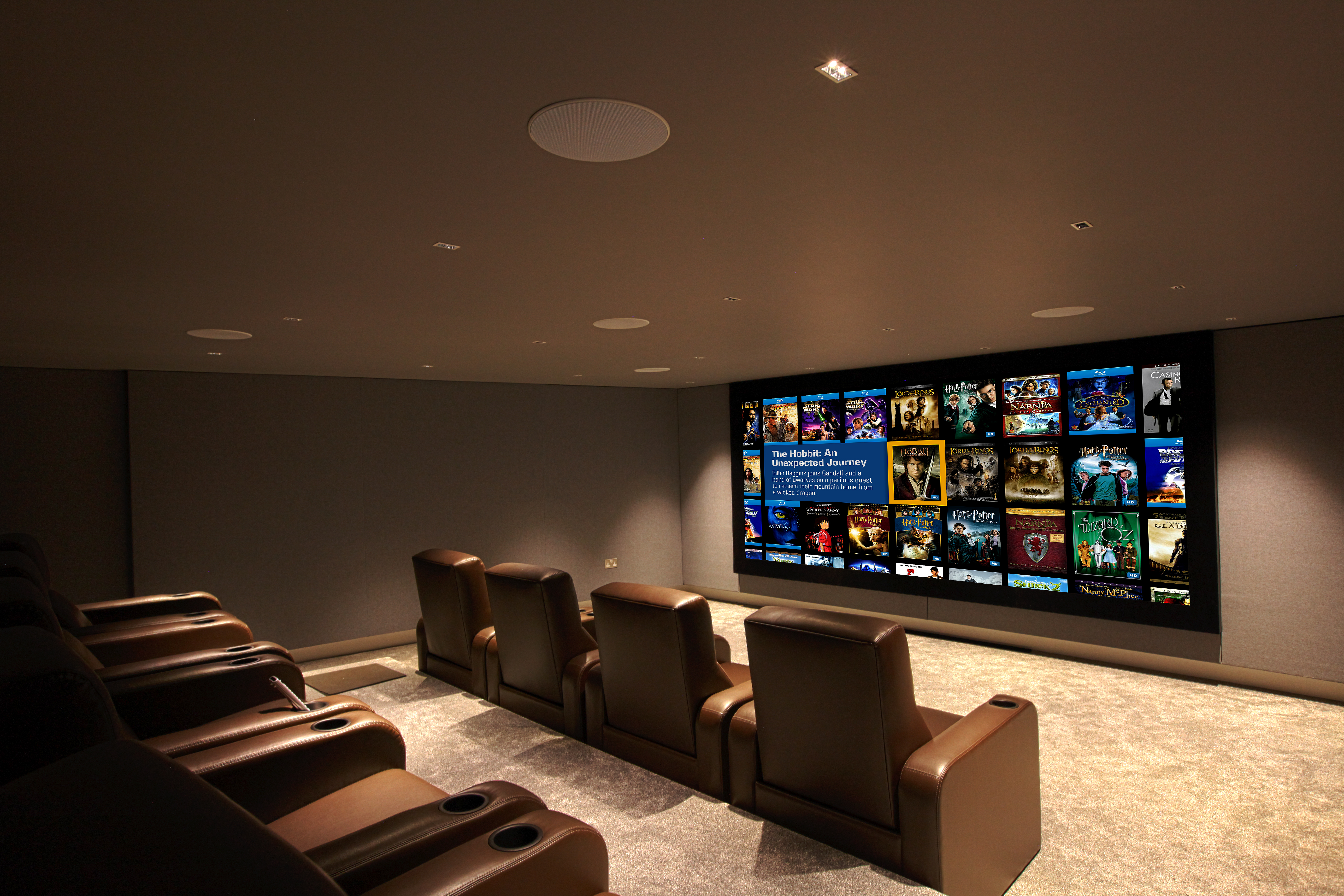 Home cinema, with leather seating and large screen showing Kaleidescape image.