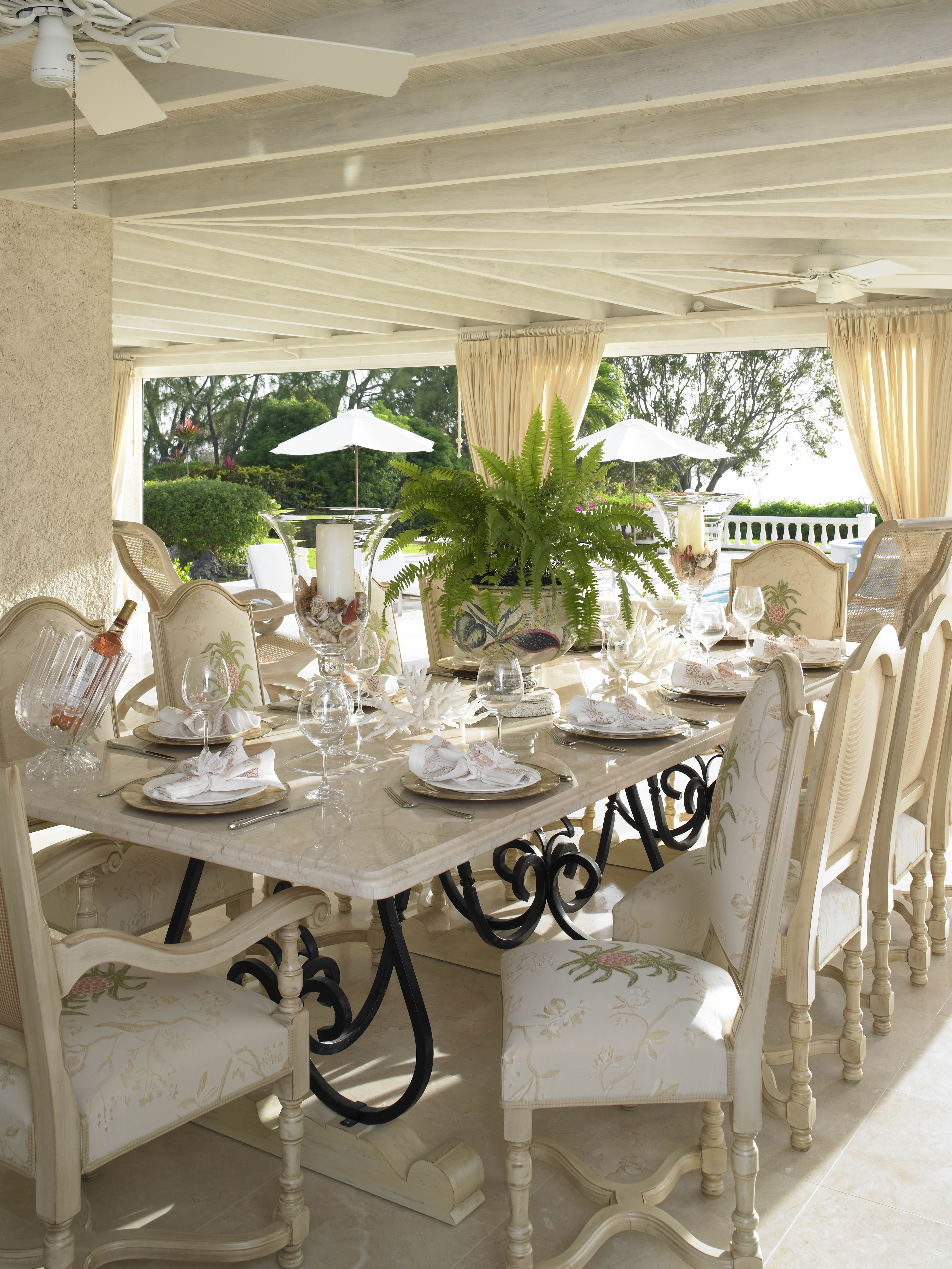 Caribbean life is all about meeting and dining with friends.  The dining area to one end of the verandah sets the tone for this elegant home.  The dining table was designed by Jenny Blanc and made in Barbados.