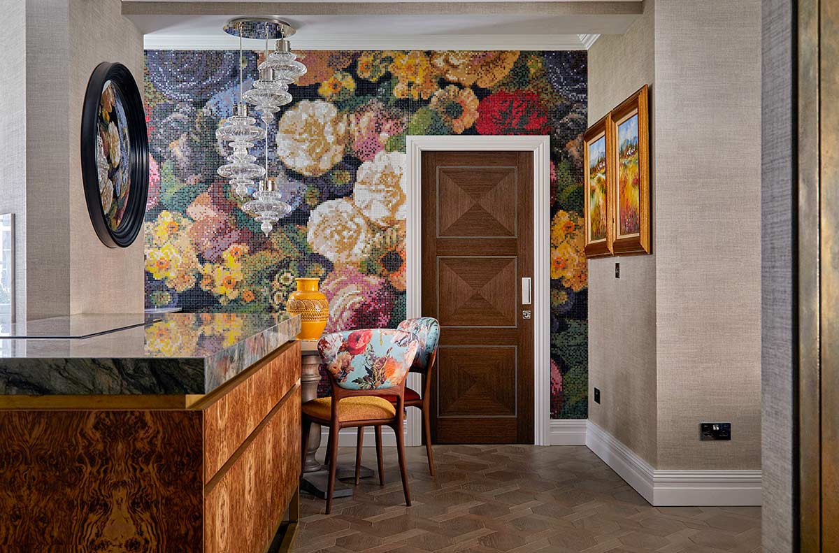 A large Bisazza mosaic piece adorns the wall behind the dining space. 