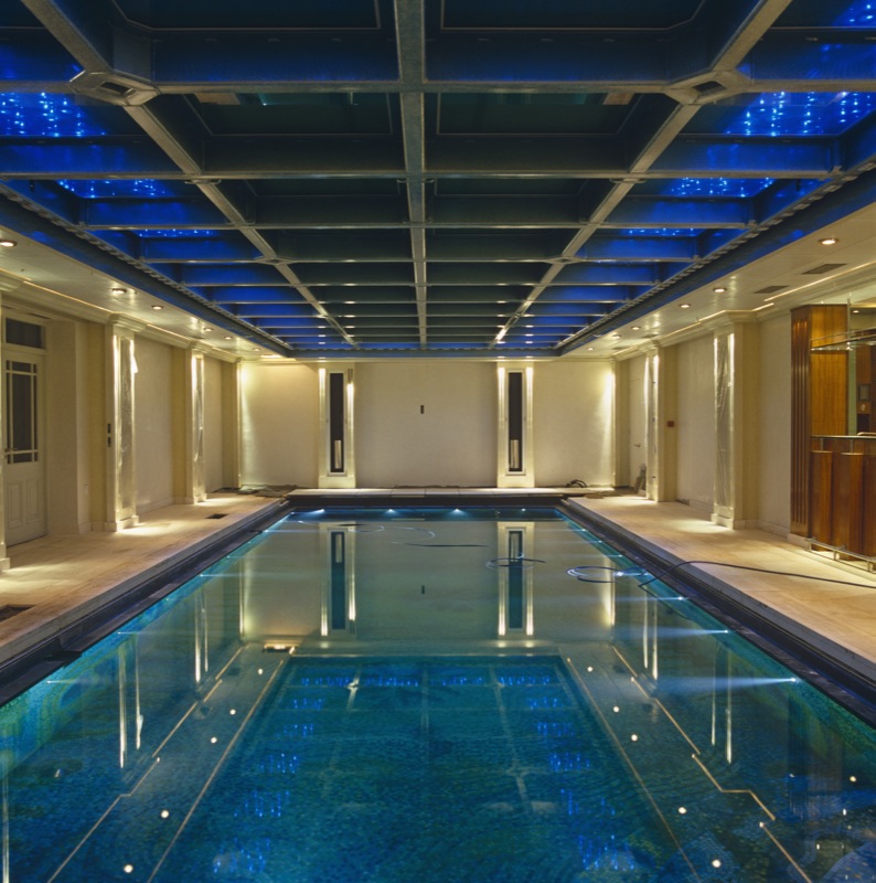 Aquamarine glass mosaic pool floor gives the feel of a Classical bathing Temple, and blue LED lighting from above creates additional drama.