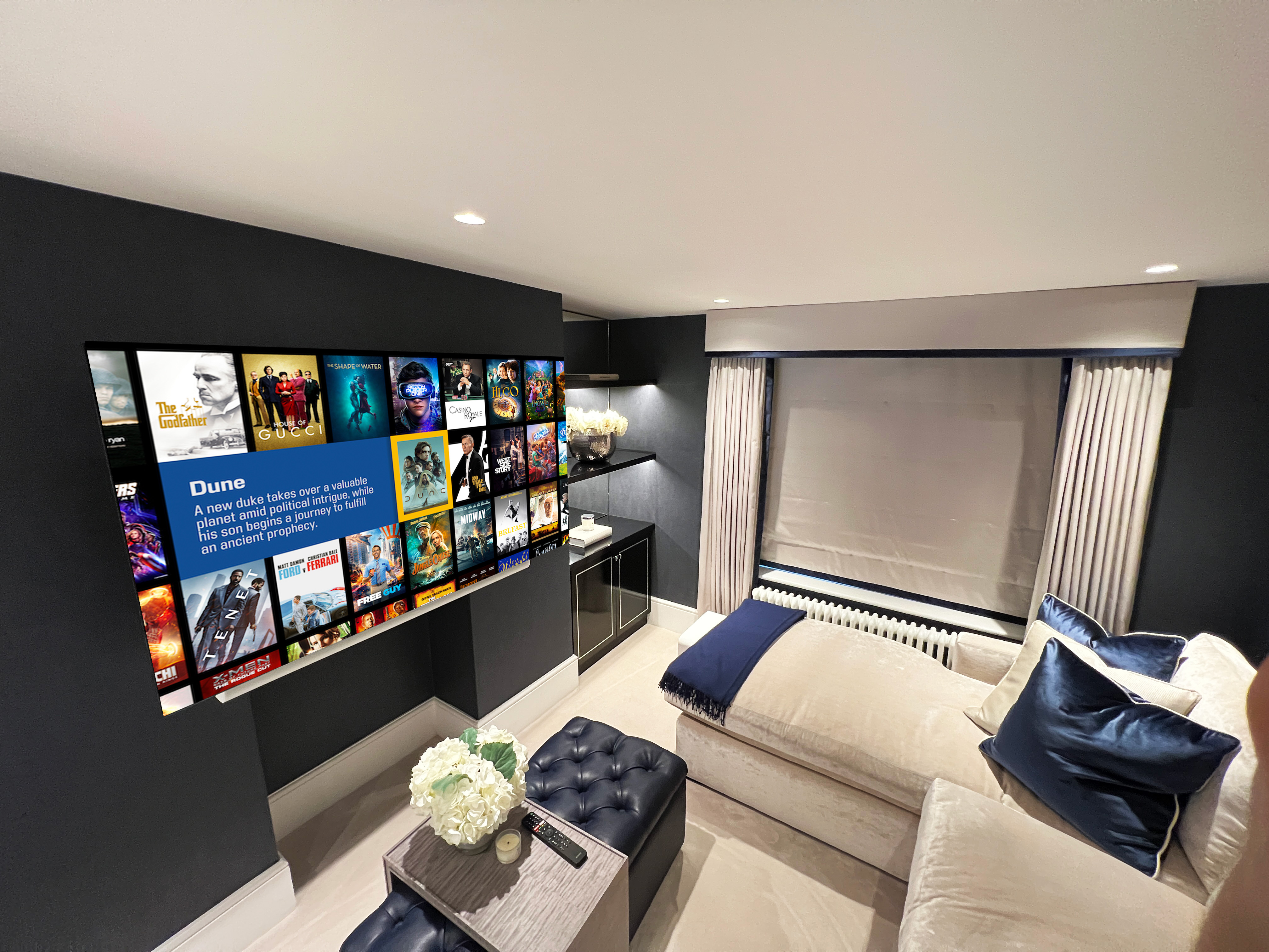 Family media room showing comfortable and plush furniture and a large TV screen with Kaleidescape.