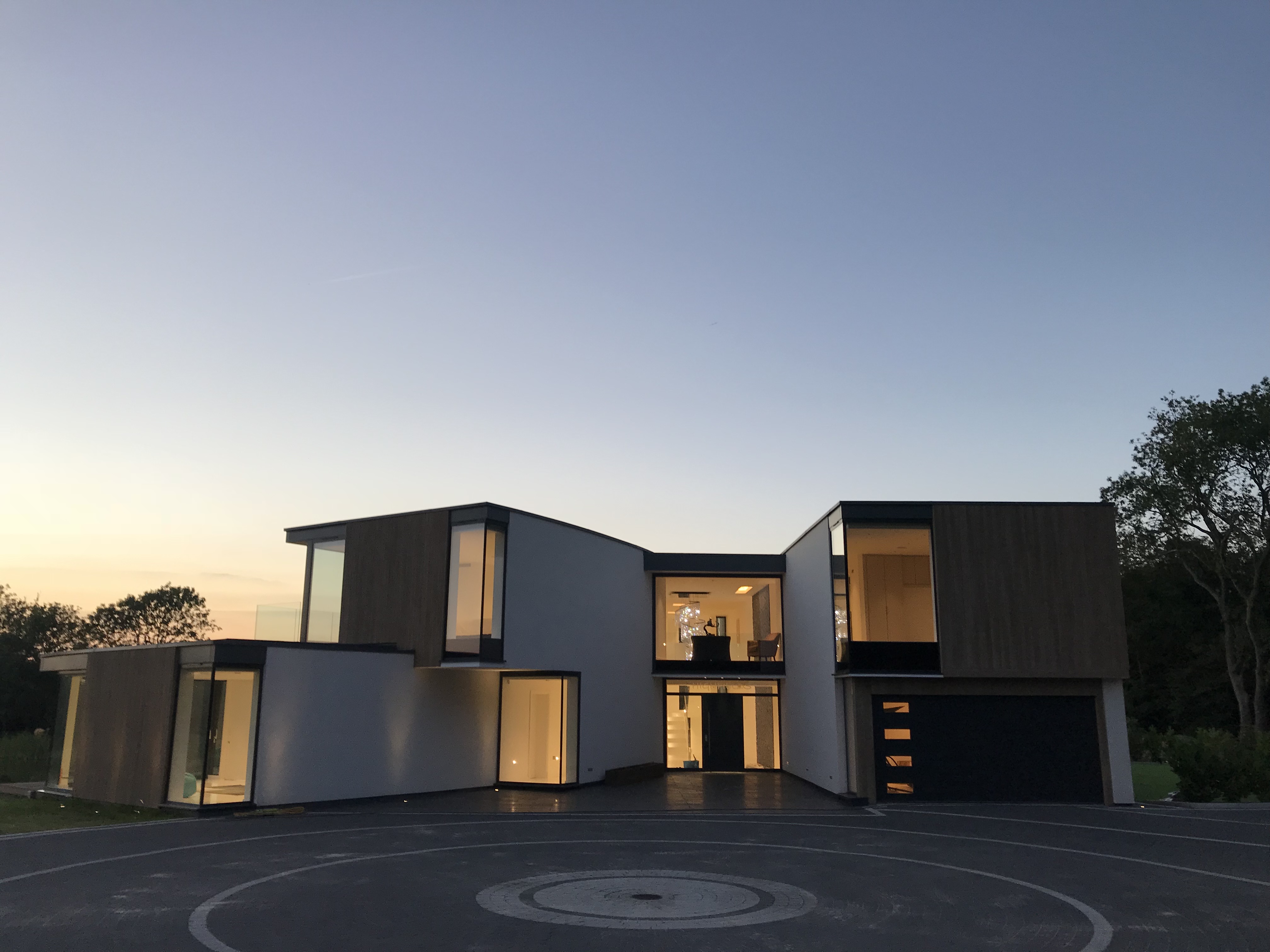 Shows home at dusk, with Lutron lighting.