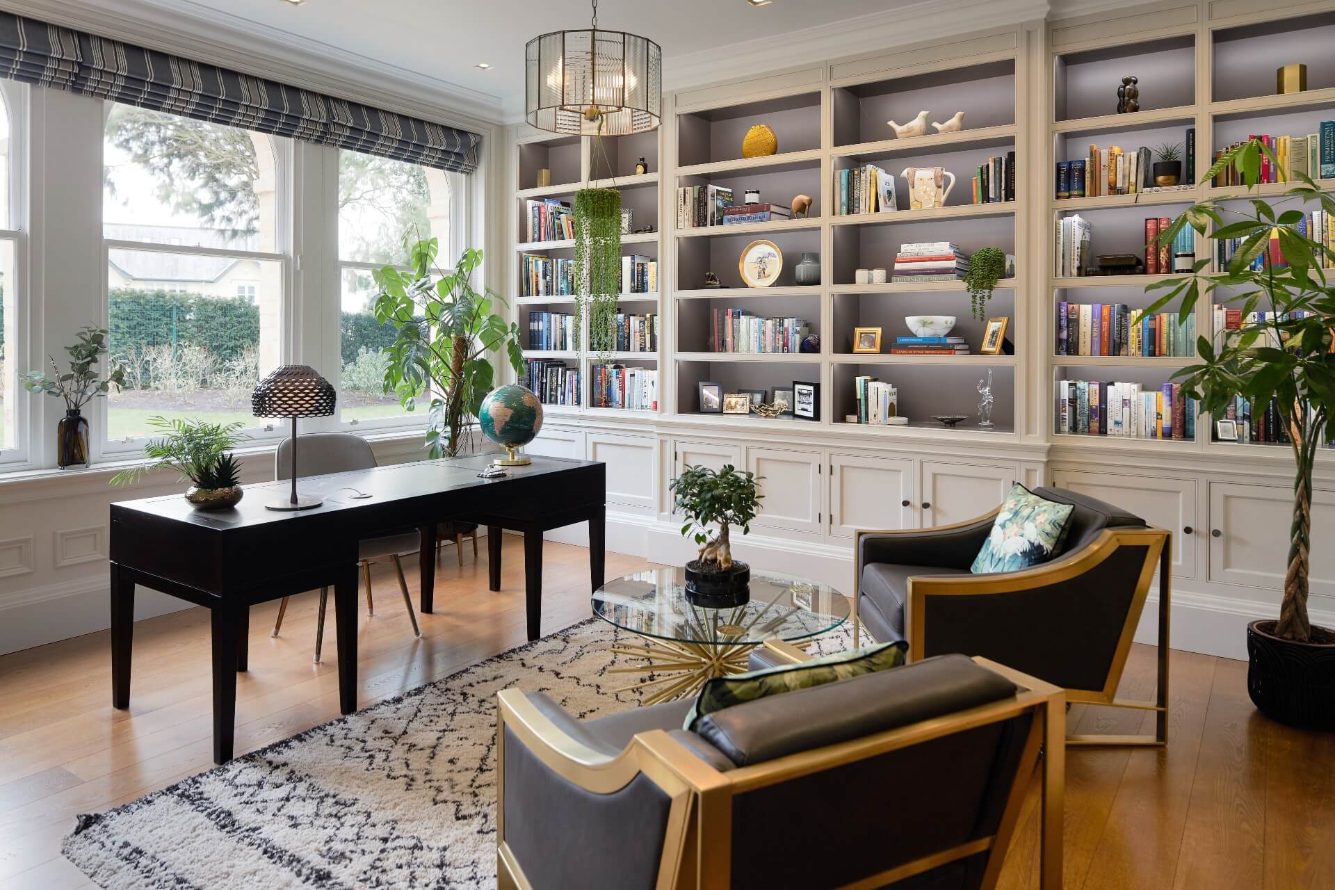 A study with a bespoke made desk and fitted shelving & units by Hetherington Newman