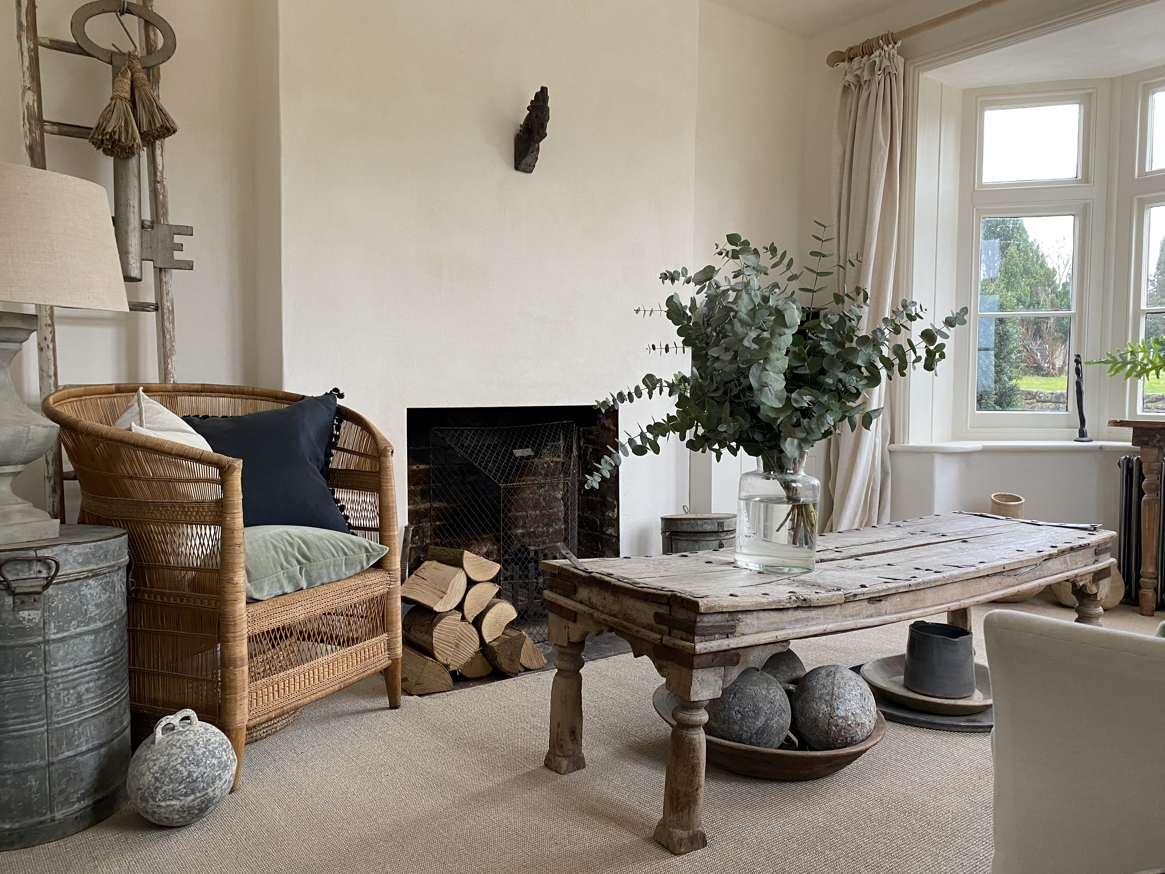 living room natural flooring fireplace white linen antique linen 