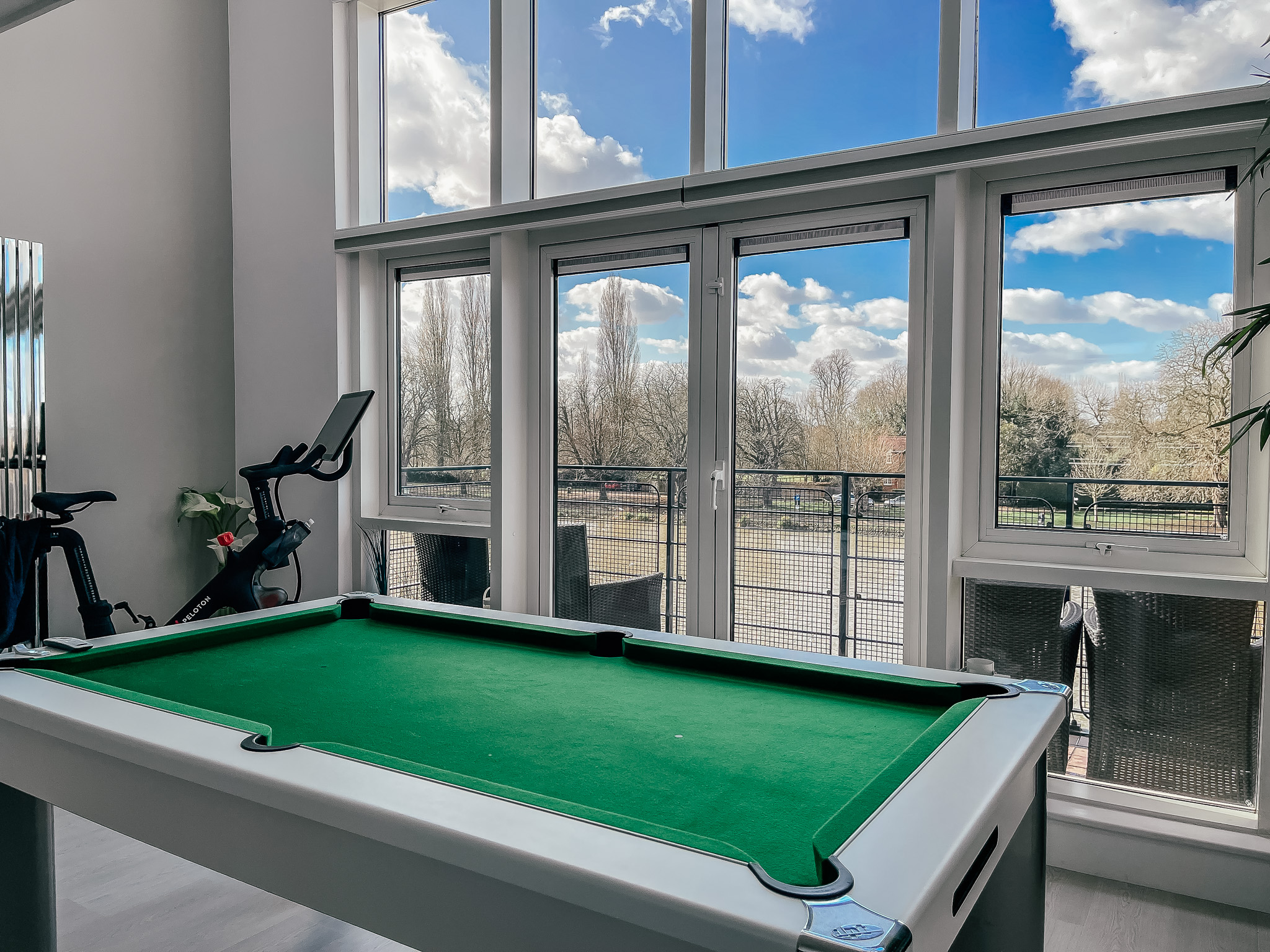 large window with river view and pool table, with discreet pleated blinds