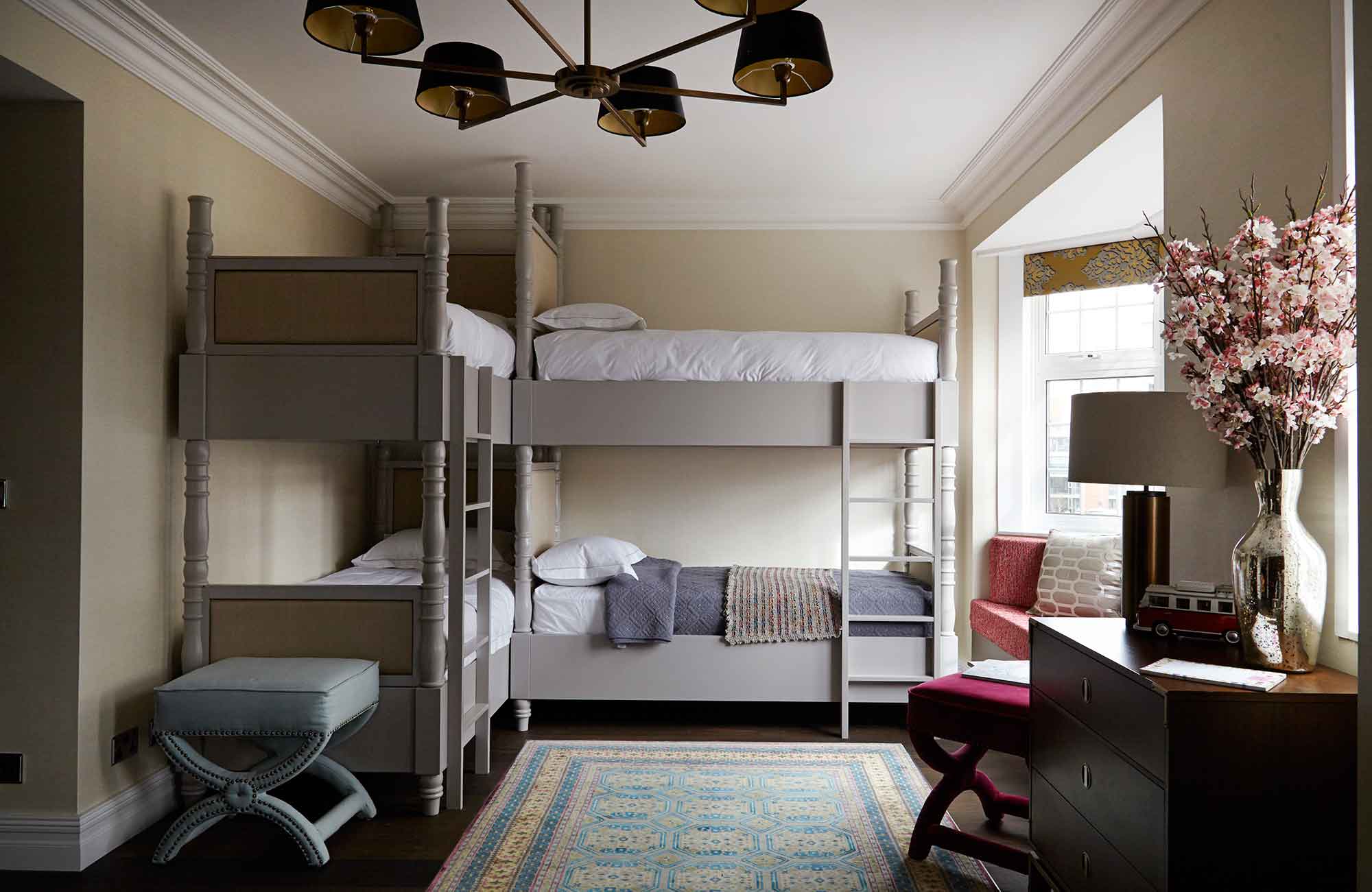 Bespoke bunkbeds and welled carpets make this room both delightful and practical 