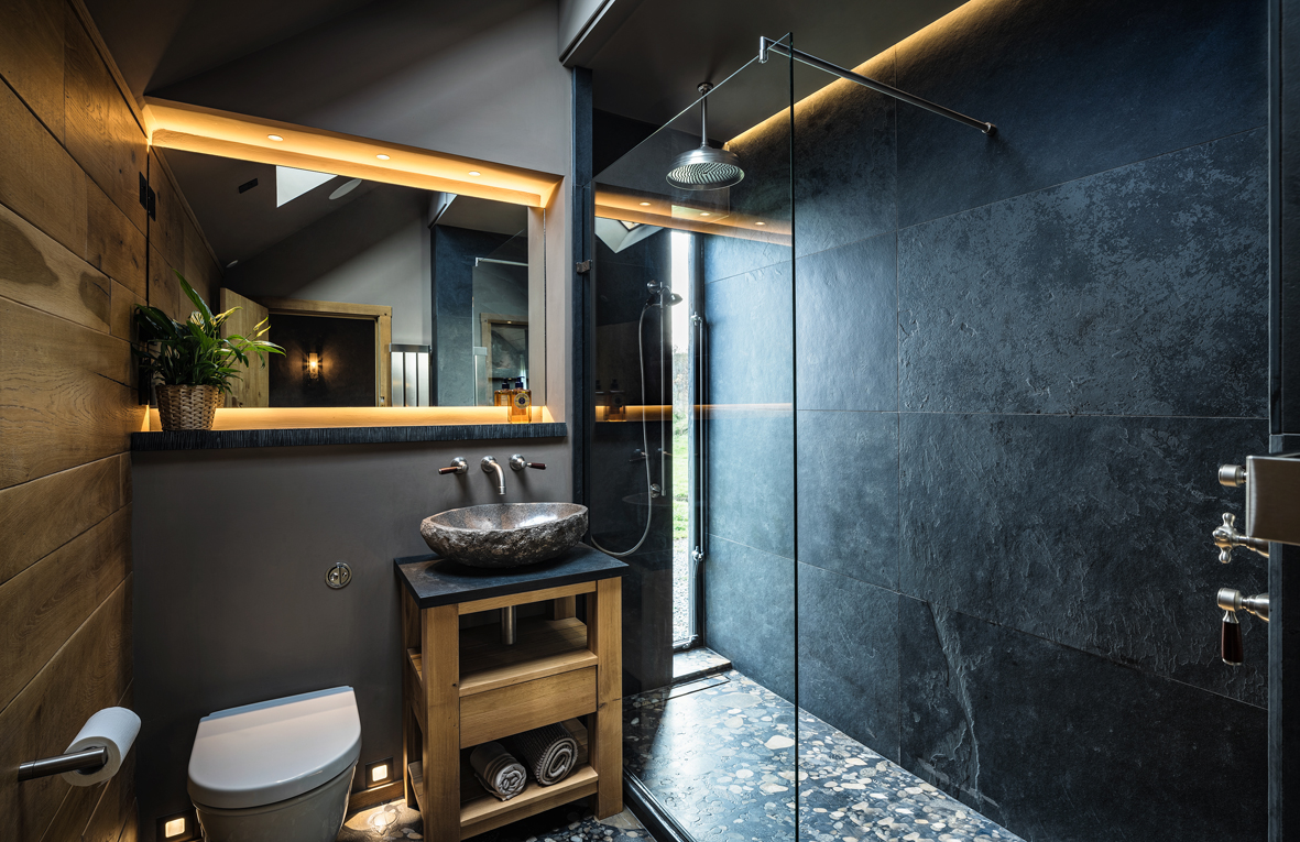 A cool masculine ensuite was created to flow from the master bedroom