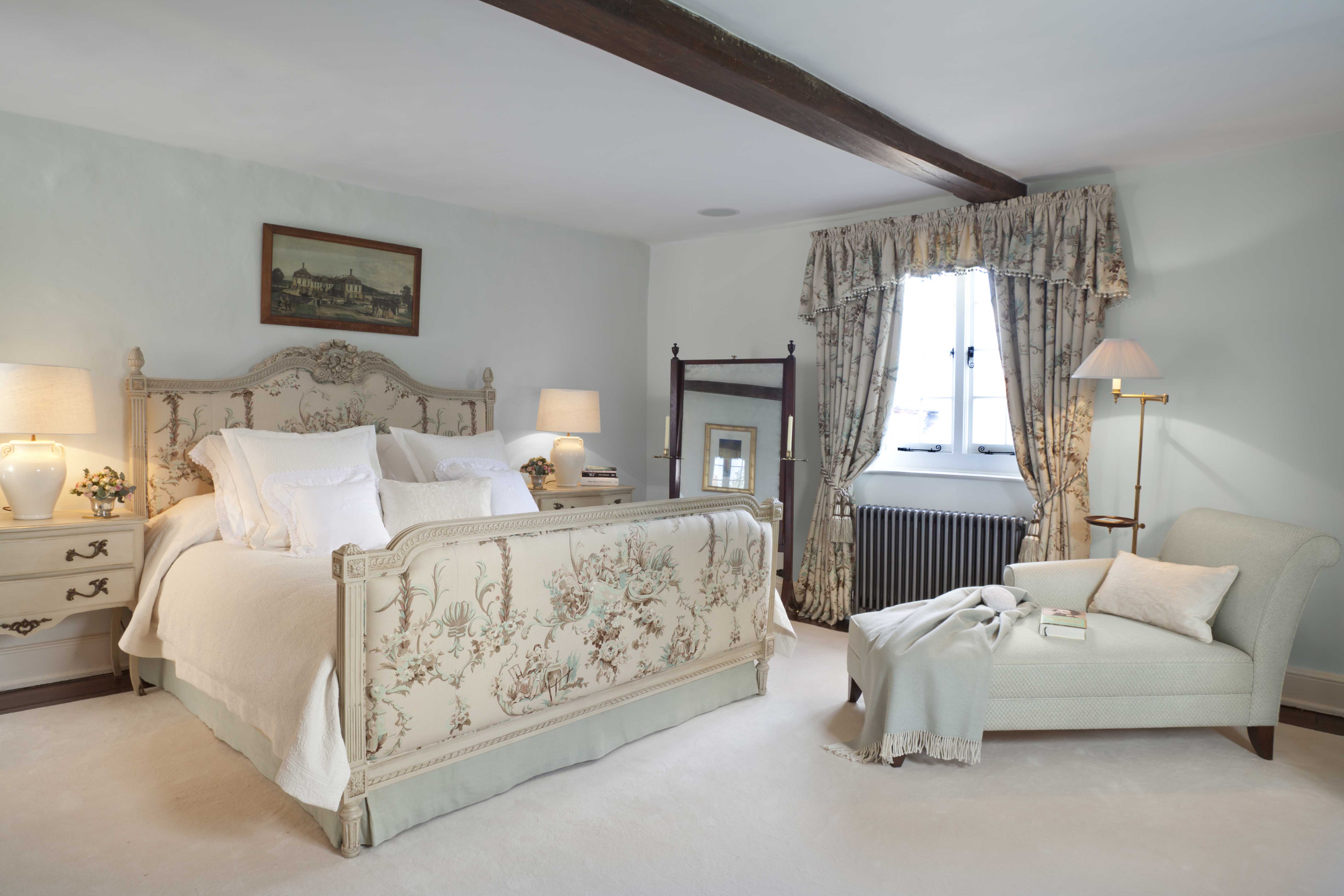 A beautiful bedroom in a soft duck egg and cream colour scheme and romantic coloured toile.
