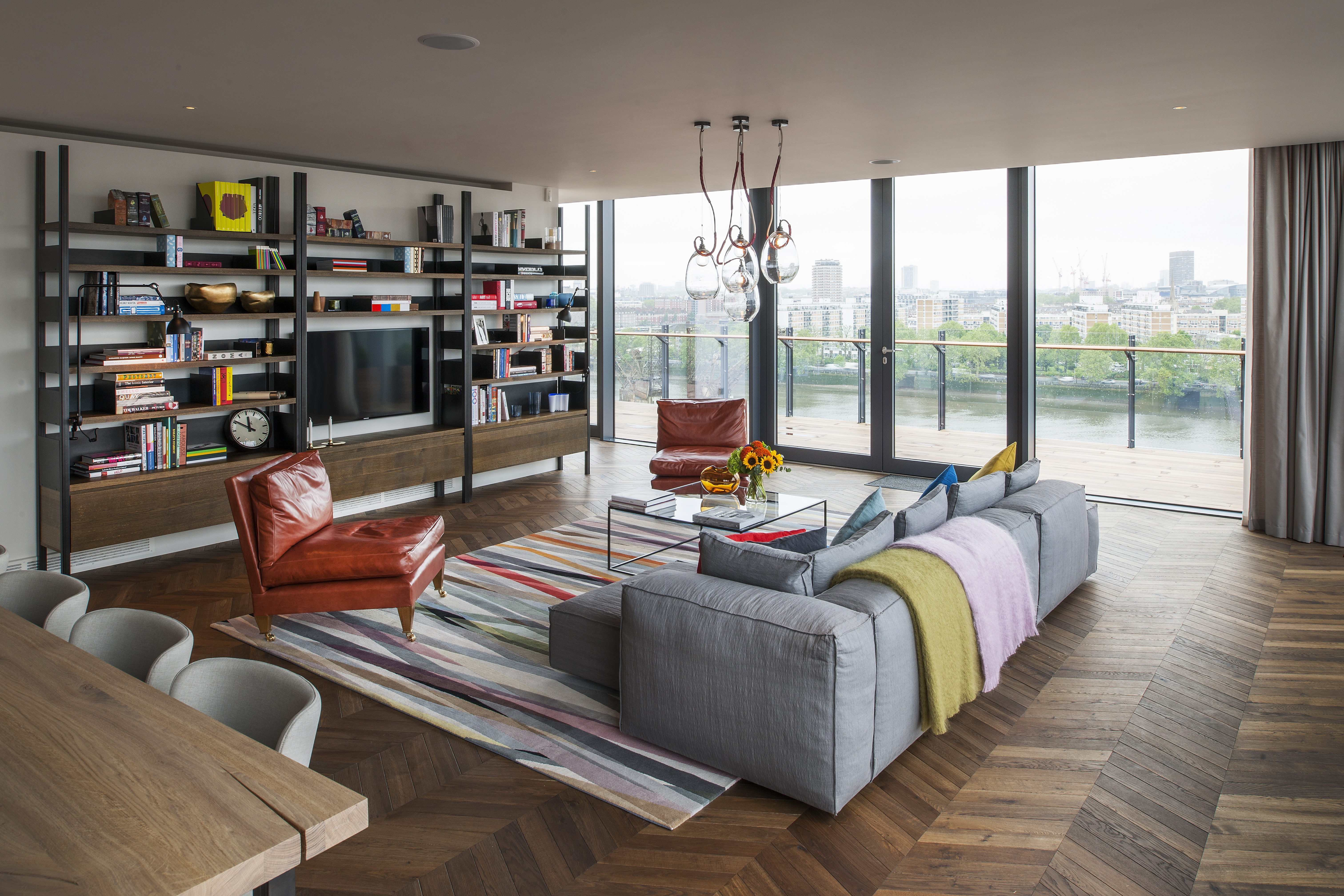 Apartment with view over the Thames river featuring a chevron timber floor.