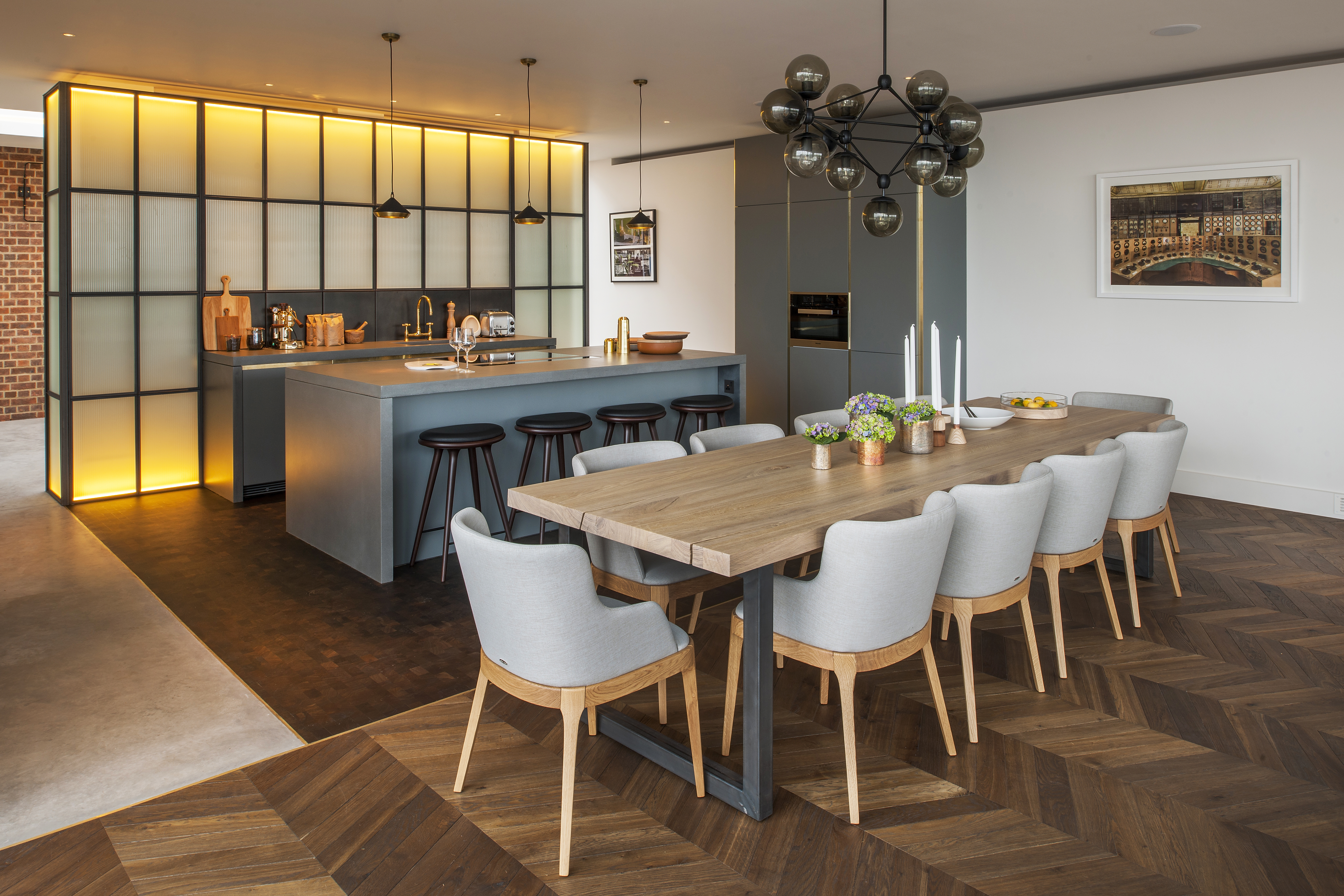 dining table with open plan kitchen and timber flooring