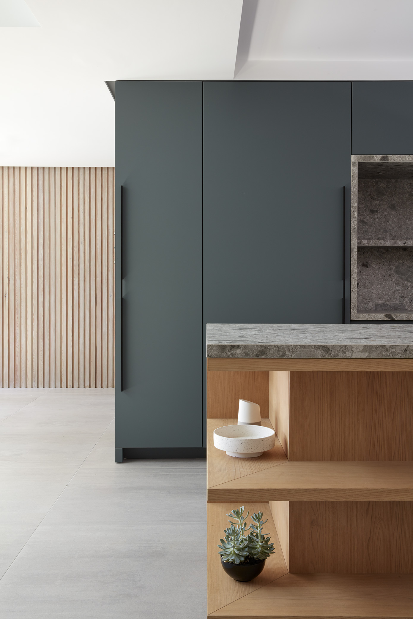 Bespoke kitchen with chestnut veneer and green Fenix cabinetry