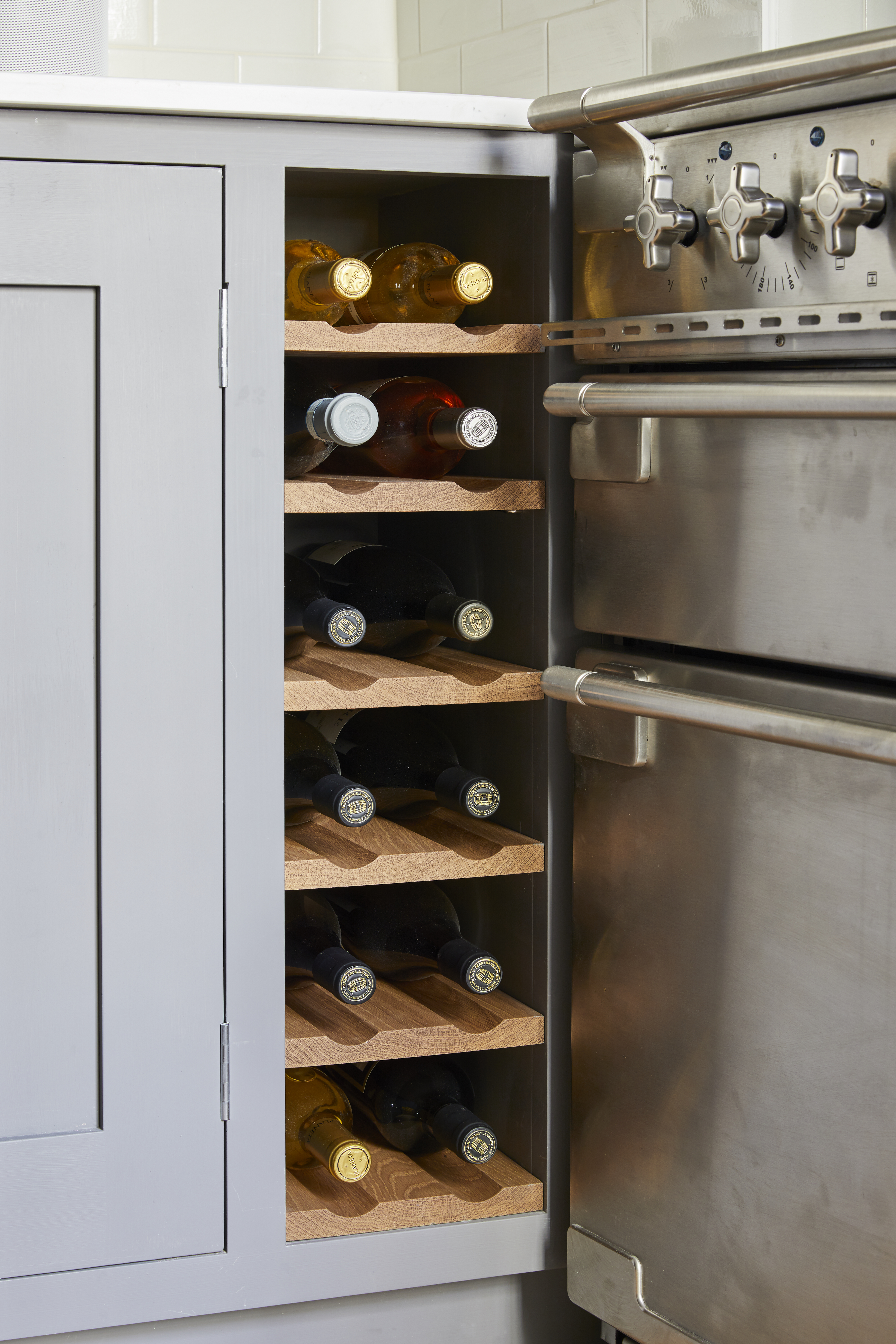 Wine storage for bespoke kitchen with grey shaker cabinets made for West London client by Holland Street Kitchens.