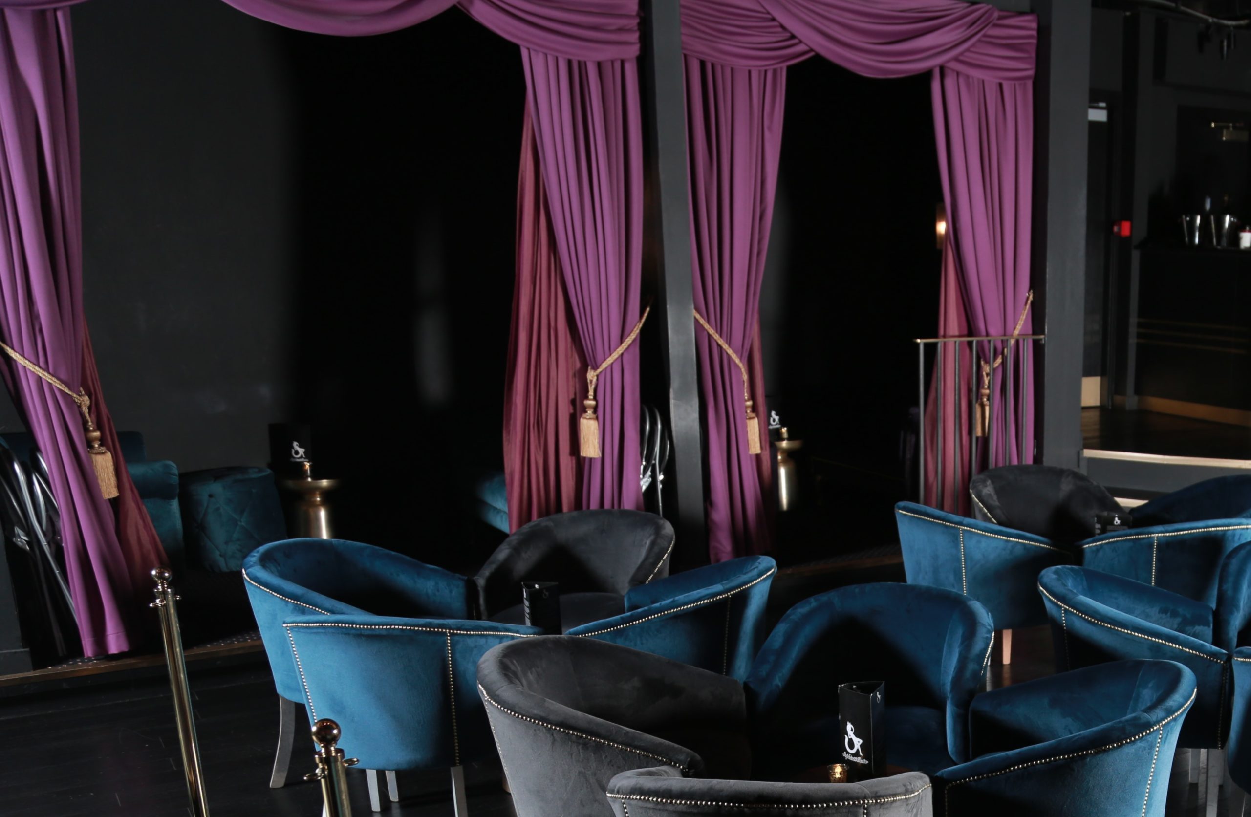 Blue and grey velvet arm chairs in club