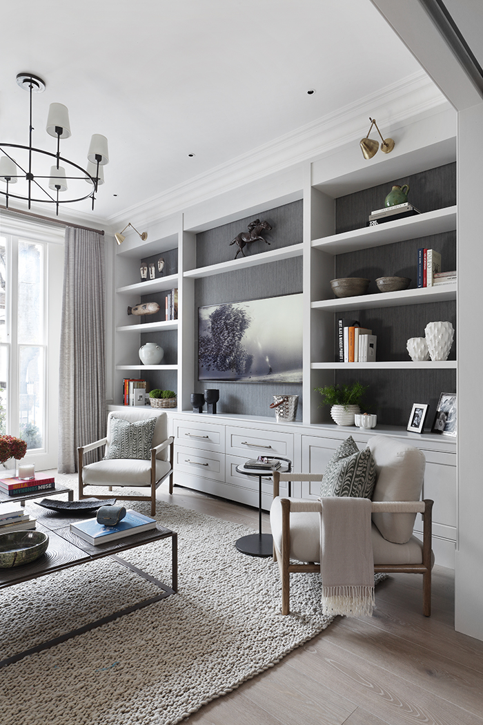 St Johns Wood Villa - reception room bookcase and armchairs