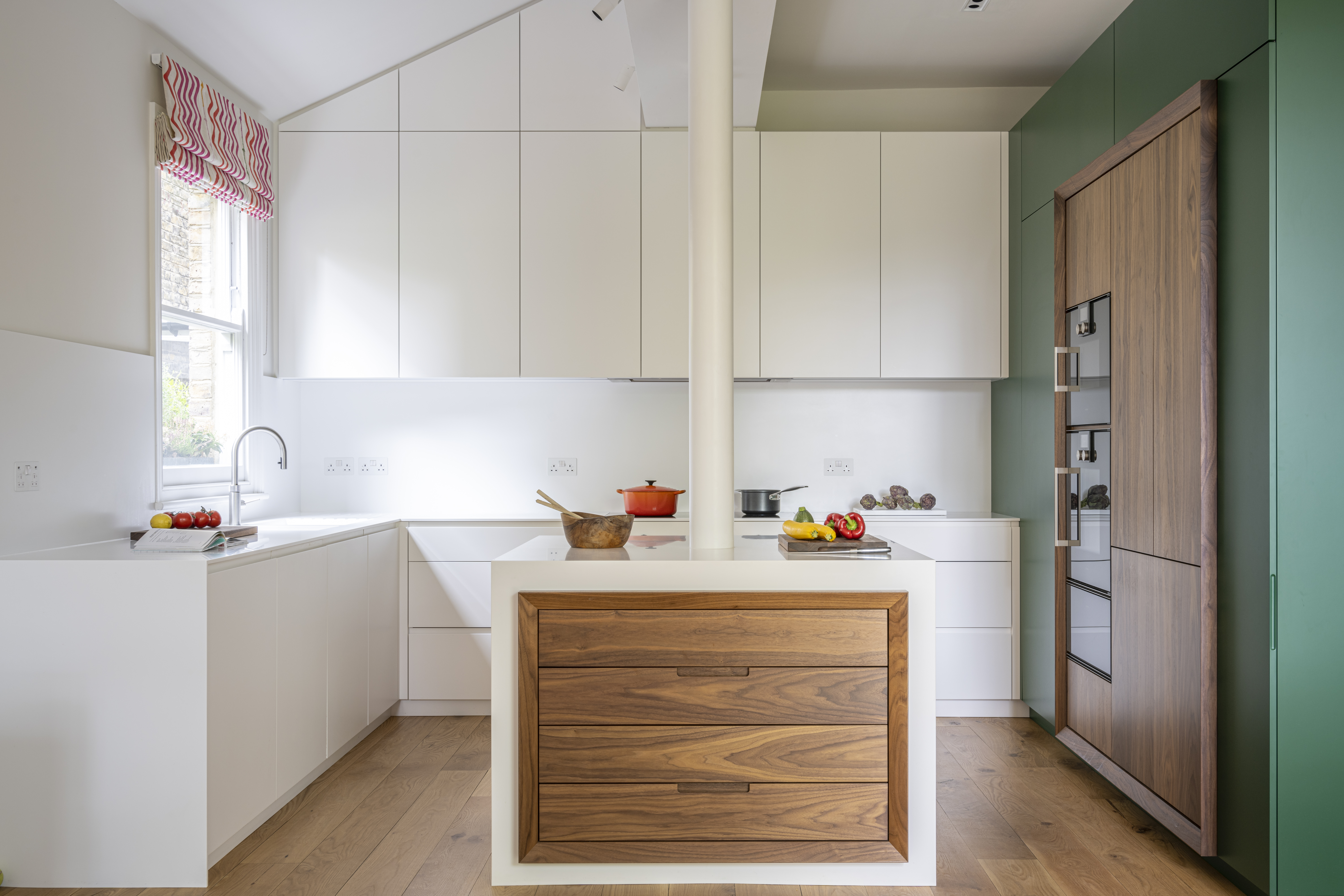 Bespoke kitchen with walnut highlights and a Corian worktop and island
