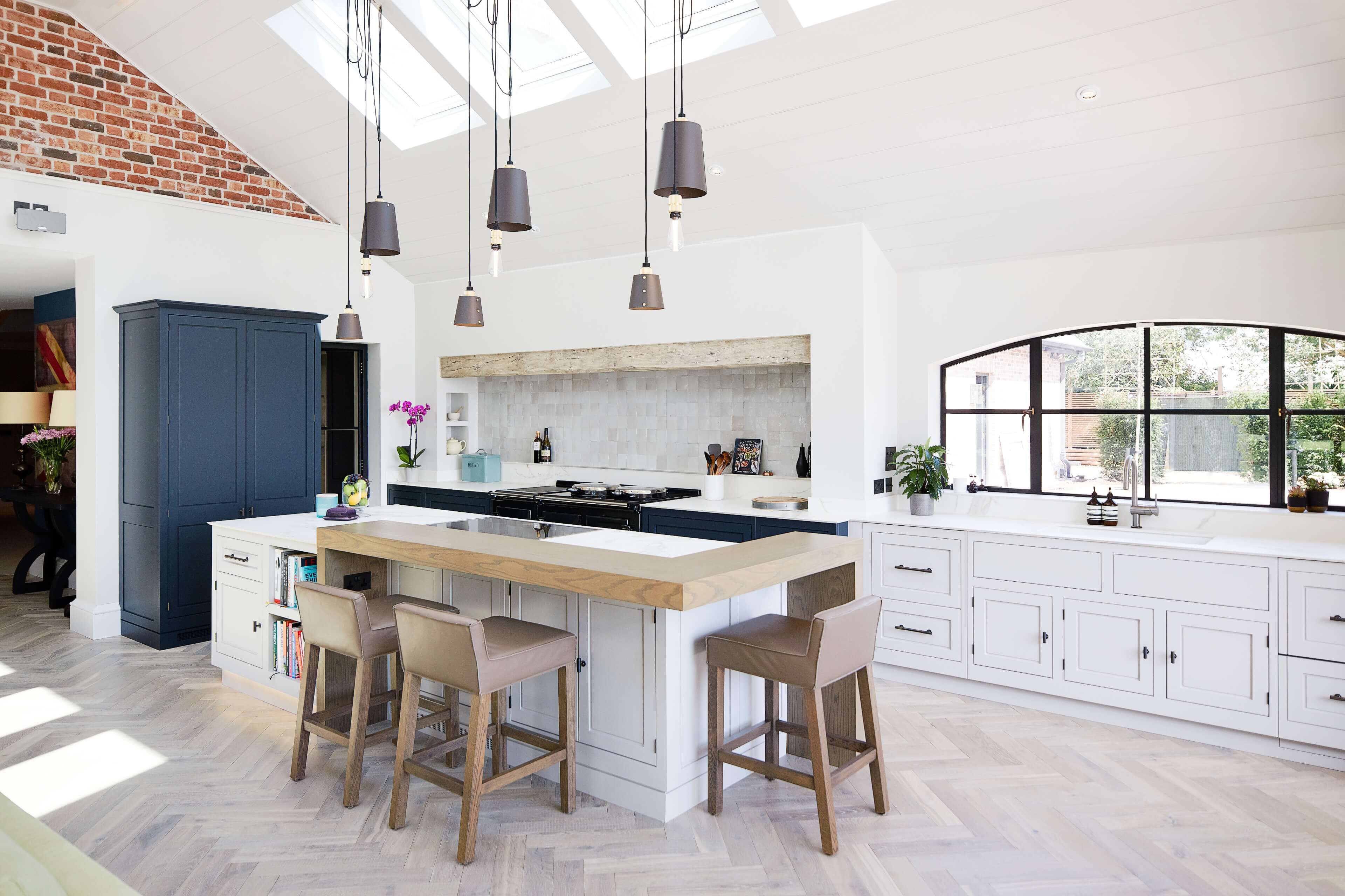 A bespoke kitchen by Hetherington Newman with a white painted base cabinets 