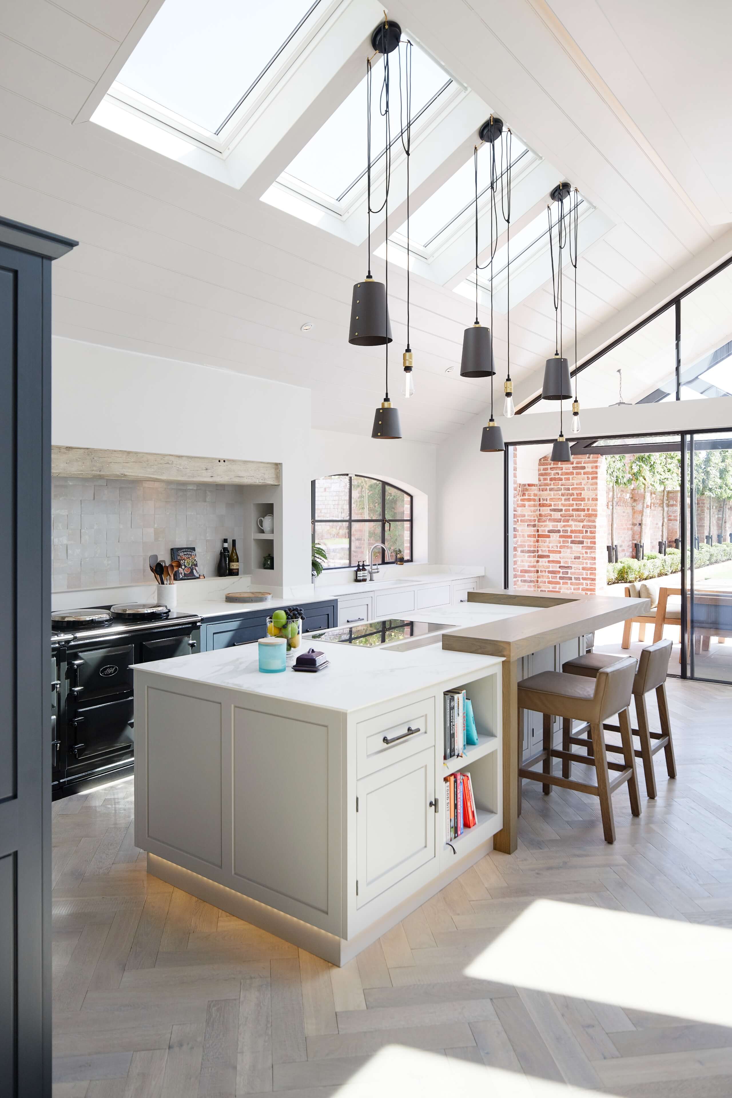 A bespoke kitchen by Hetherington Newman with a white painted base cabinets and white AGA cooker