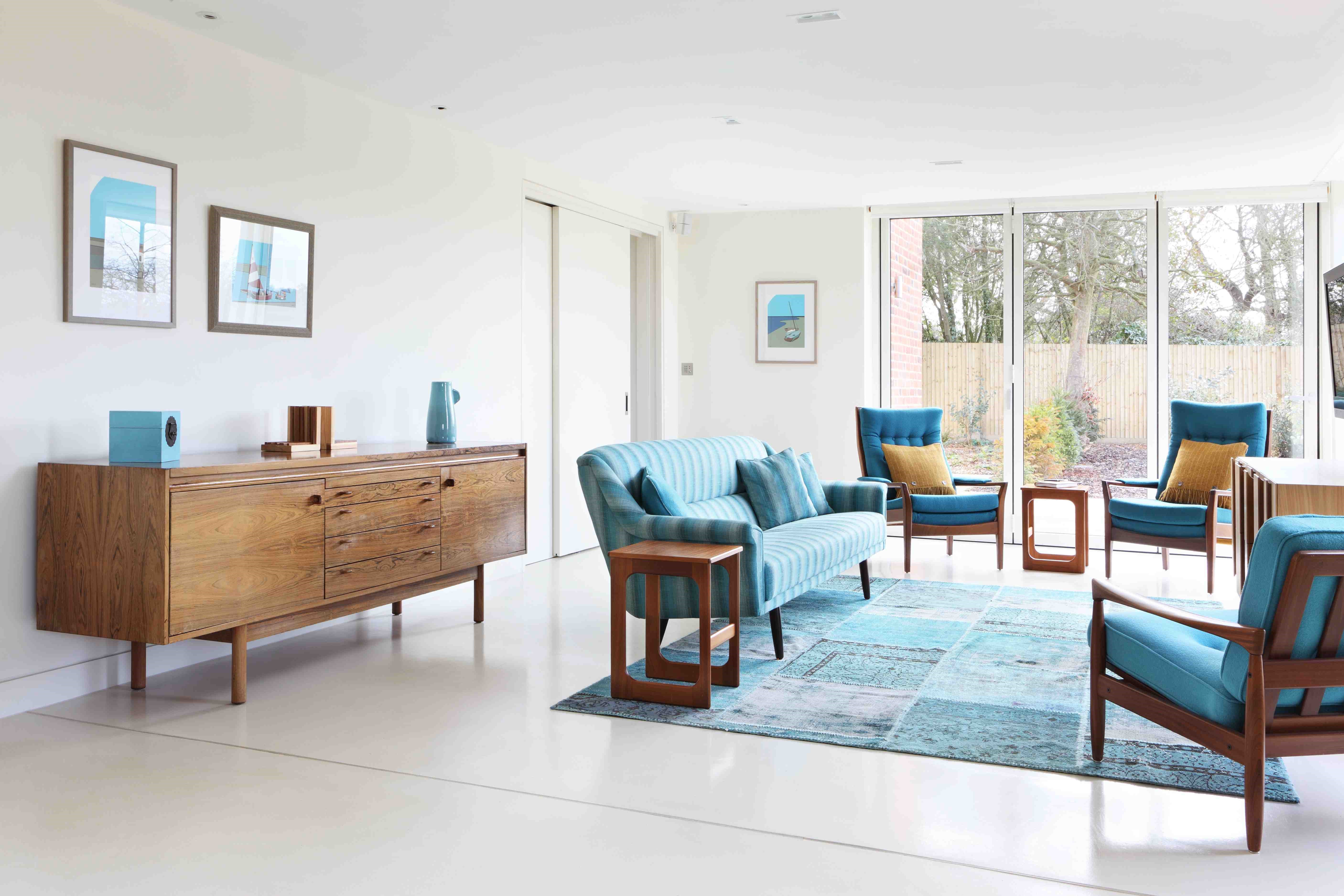 Family room; mid century furniture; modern british design; blue accent; gallery interior