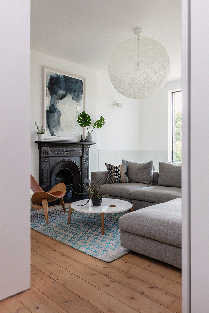 AScandi-inspired living room featuring an original cast iron fireplace surround