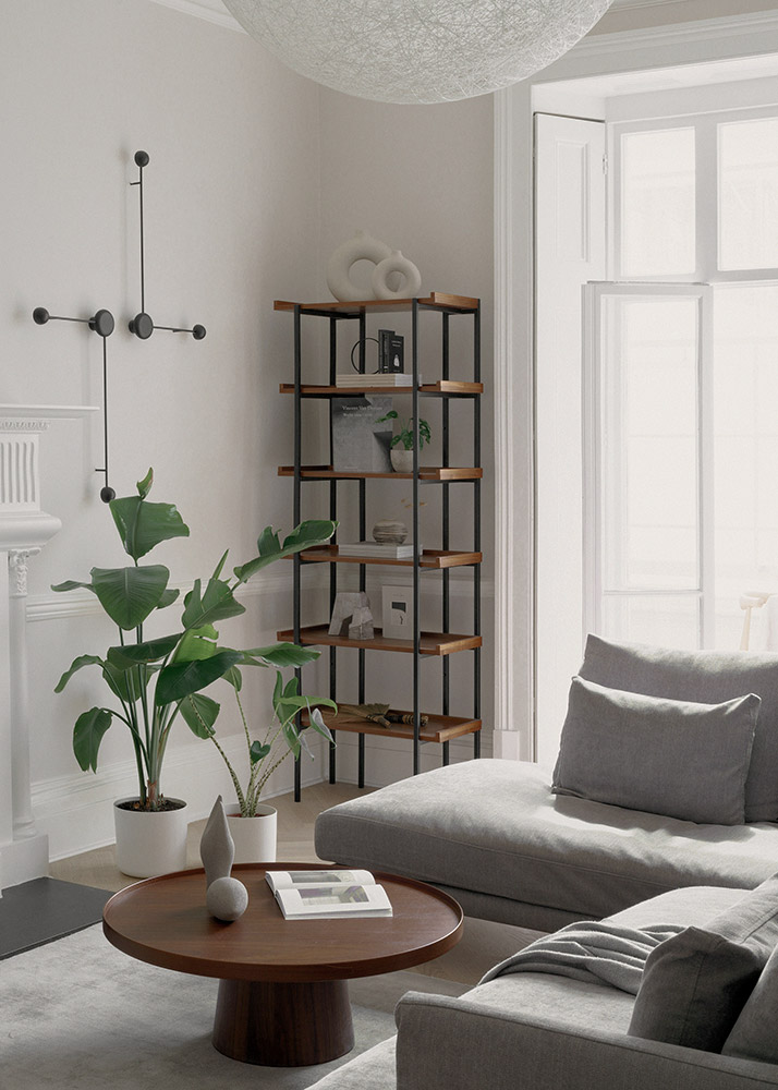 Bespoke freestanding shelving storage enhances the Scandinavian-inspired living room.