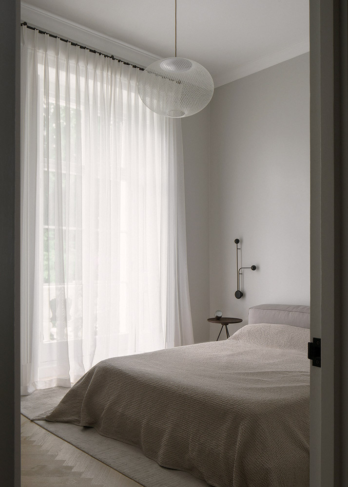 Warm minimalist bedroom in period property