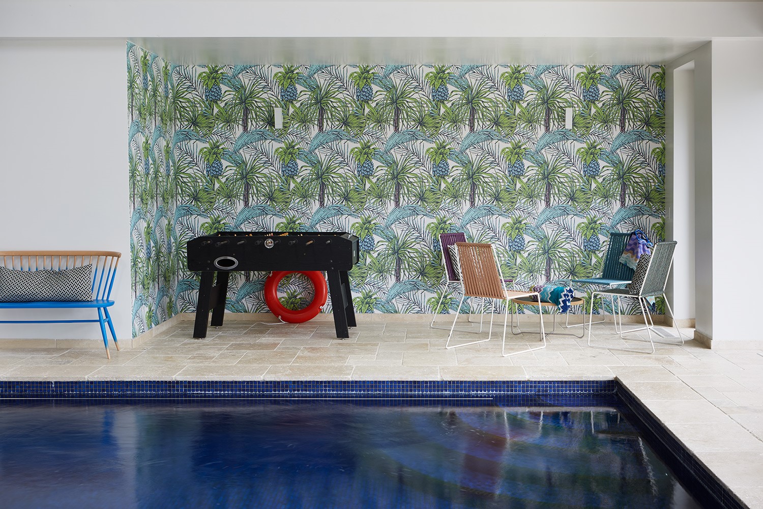 Swimming pool; bespoke mural; bespoke wall paper; table football; blue mosaics; Ercol bench