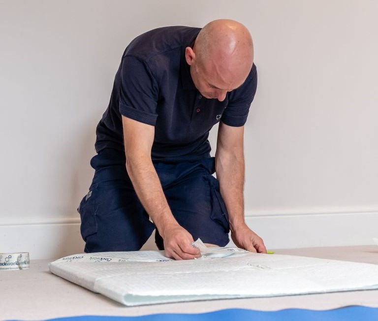 A Clockwork Removals team member carefully wrapping an item for protection.