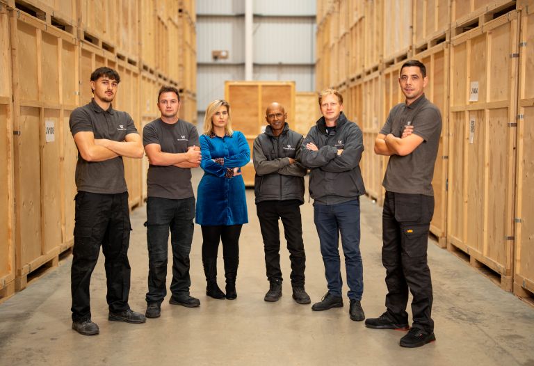 Six members of the Williams & Yates team arms folded looking at the camera in a warehouse setting