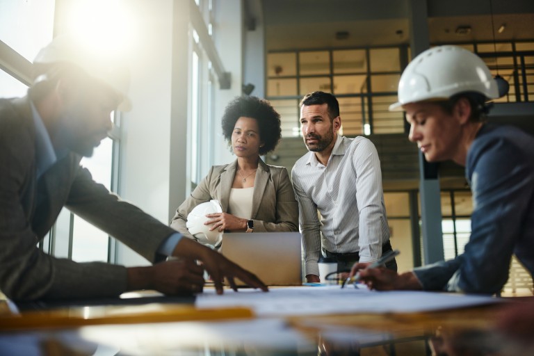 Designers around plans