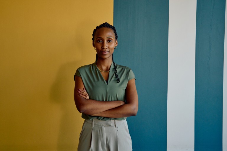 Woman in front of painted walls looking confident
