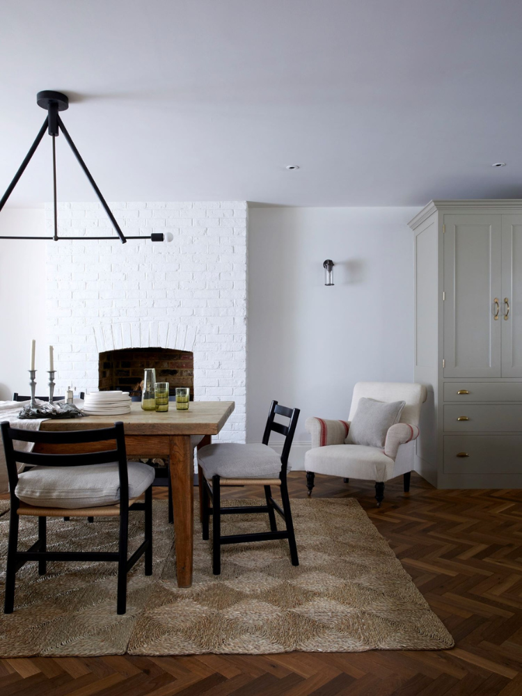 Dining Room with oak table on jutte rug and herringbone parquet.