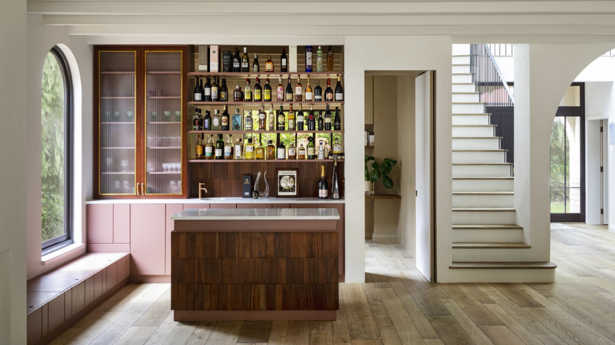 interior with textured oak flooring, matching staircase and homebar.