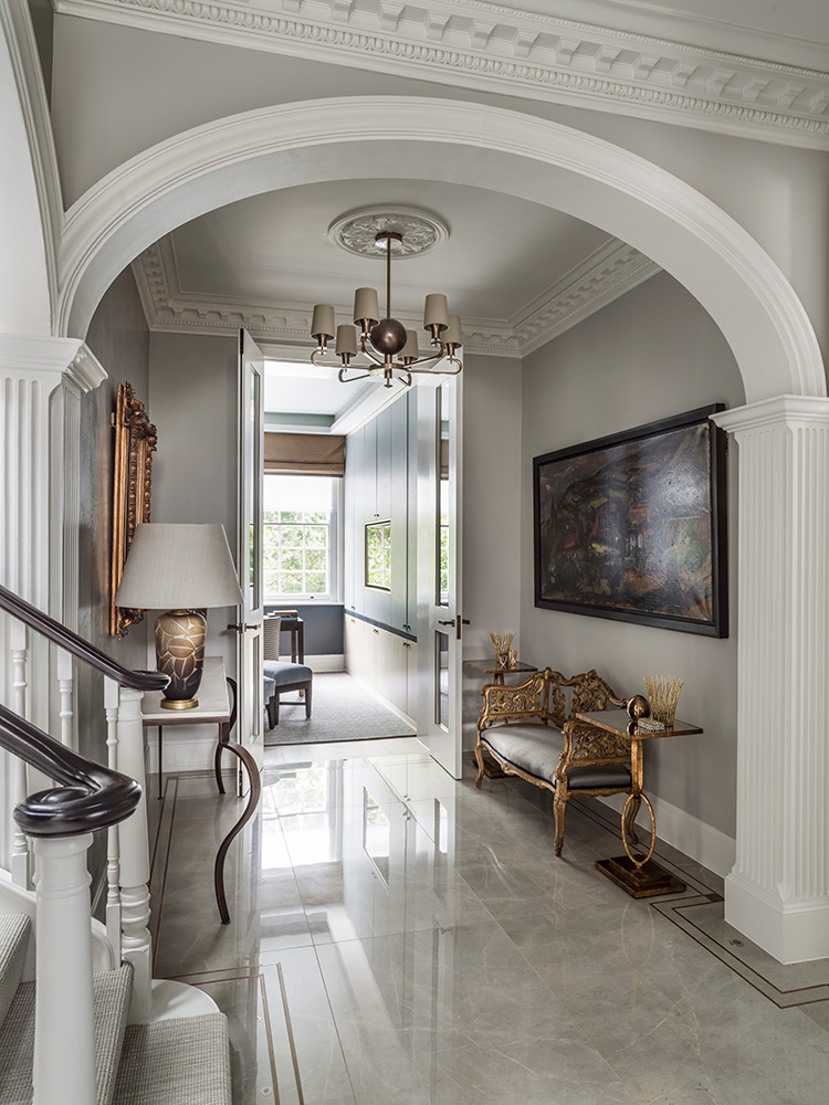 luxurious entrance hall with staircase, arch and period details